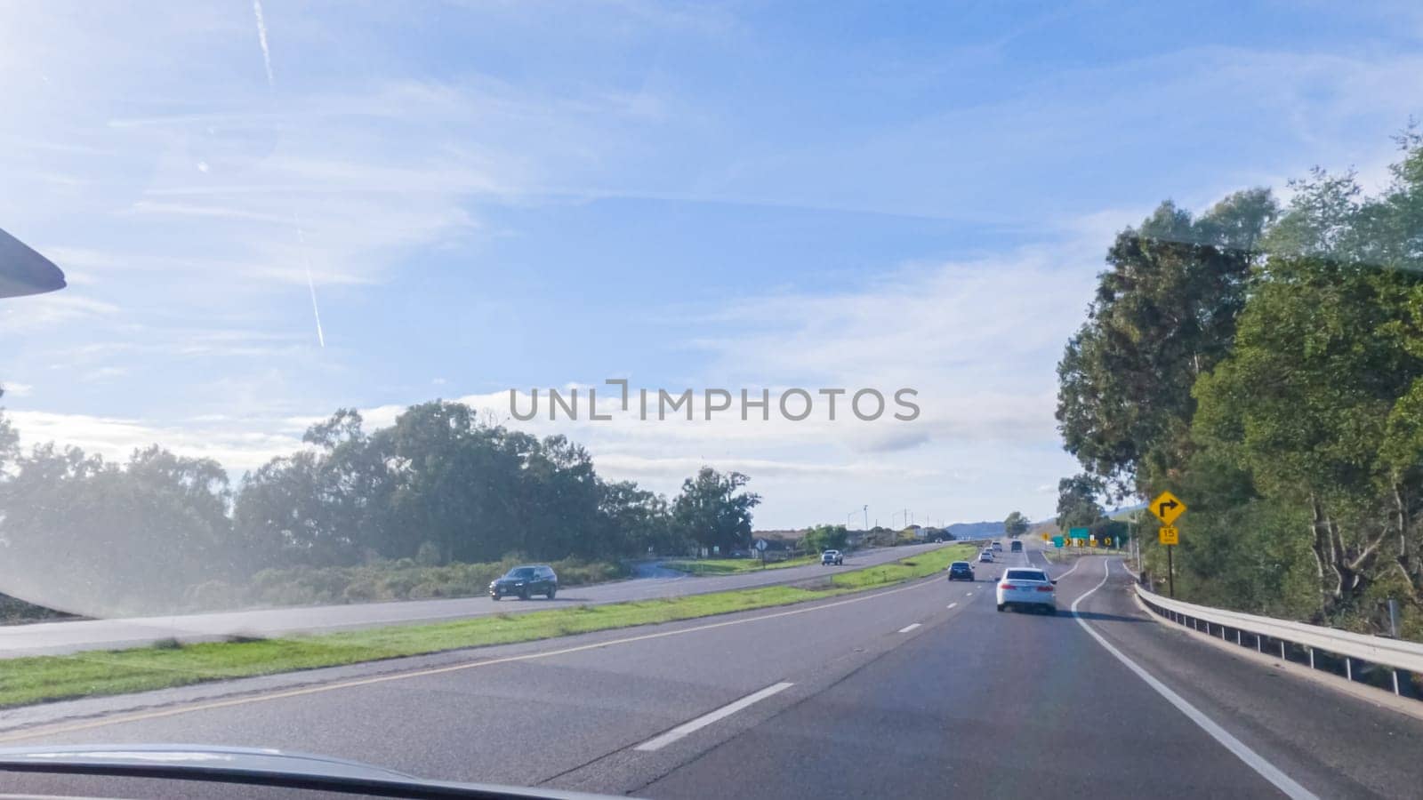 Los Angeles, California, USA-December 4, 2022-POV-Driving on HWY 101 near Santa Barbara, California, the road is shrouded in cloudiness during winter, creating a moody atmosphere while still showcasing the beauty of the coastal landscape.