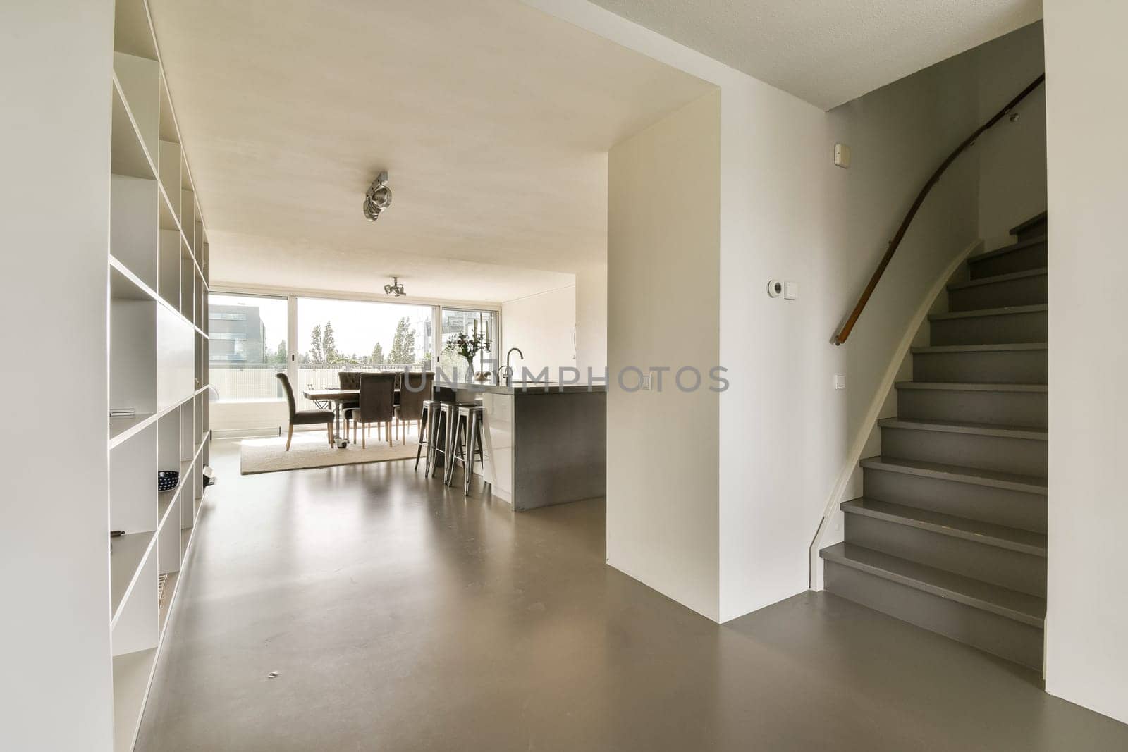 a living room with stairs leading up to the kitchen and dining area on the left side of the room is an open floor plan