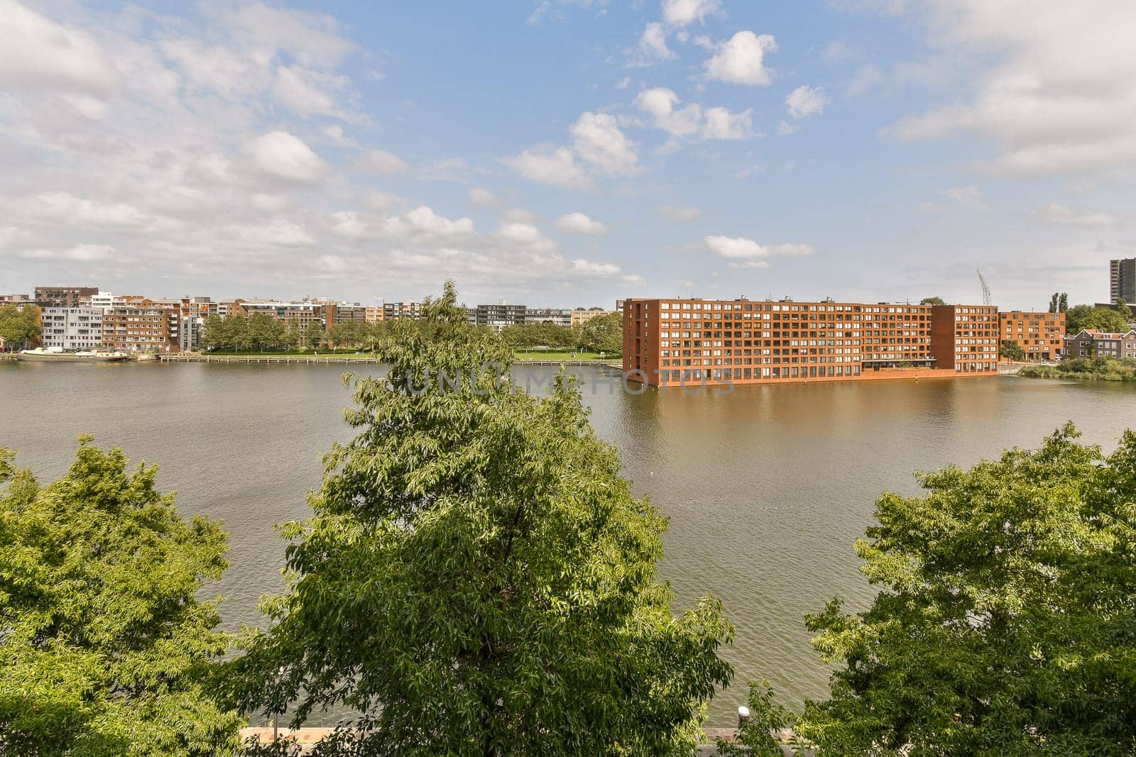 a view of a lake with a city in the by casamedia