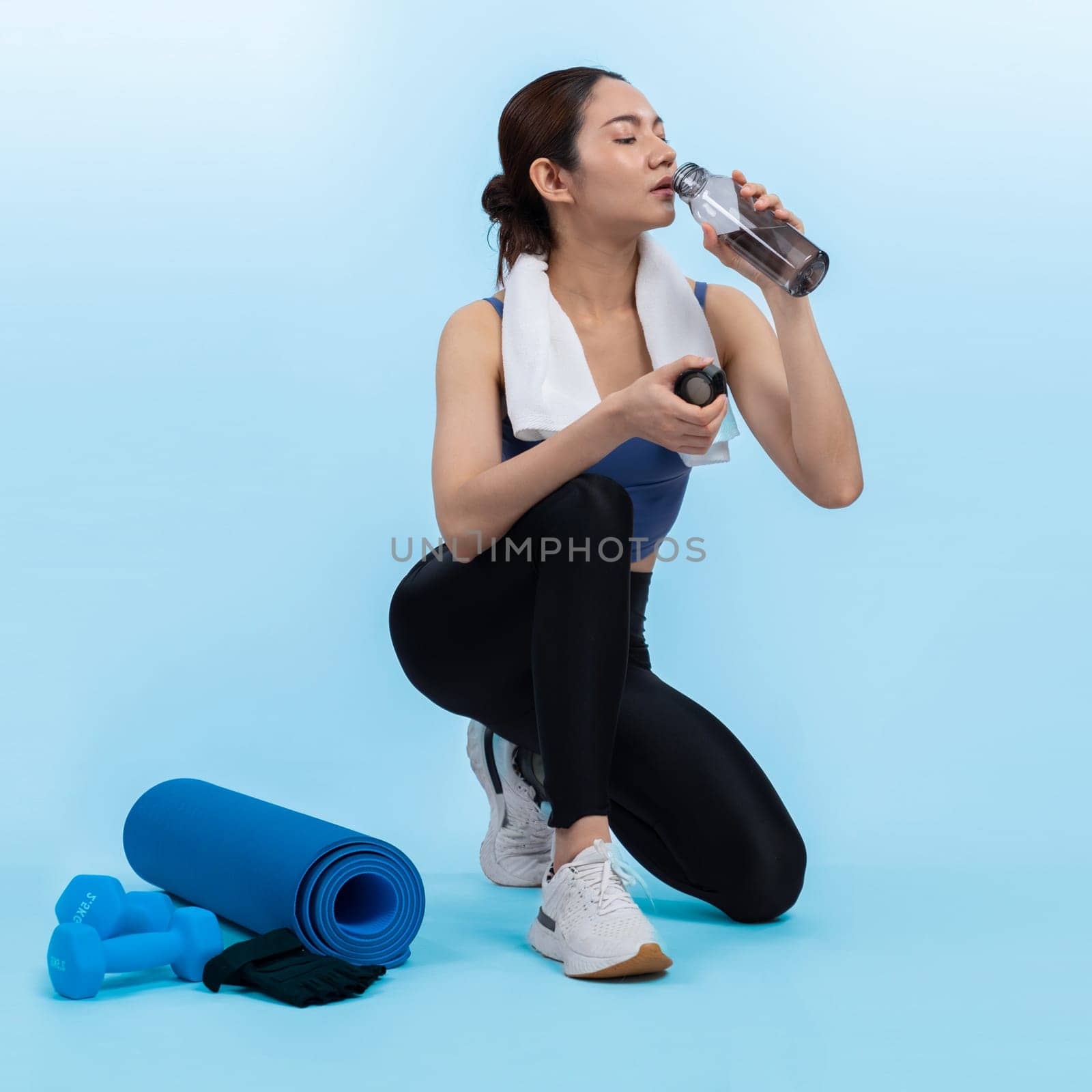 Athletic and sporty asian woman resting after intensive cardio. Vigorous by biancoblue
