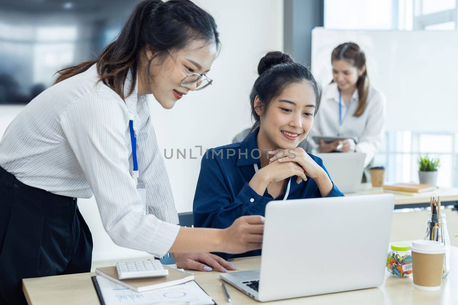 Employees discuss brainstorming planning business strategy together in the office.