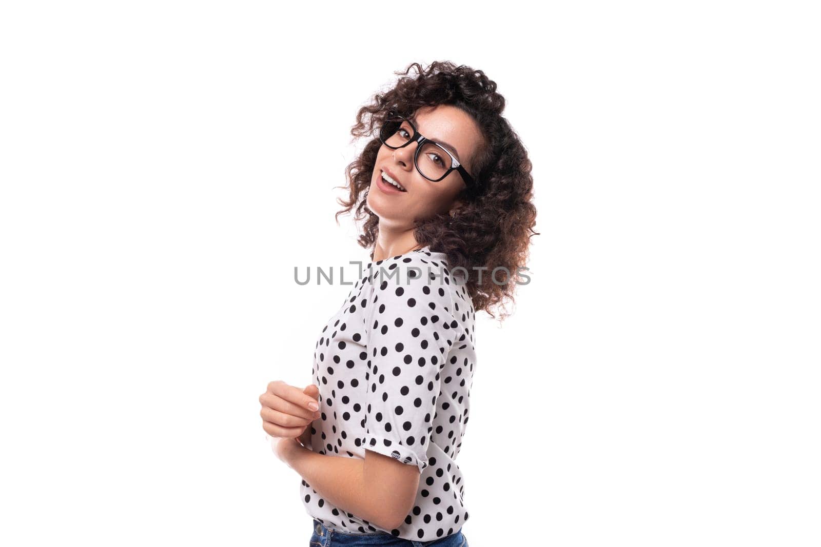 young stylish caucasian woman with curly perm hair looks happy and confident.