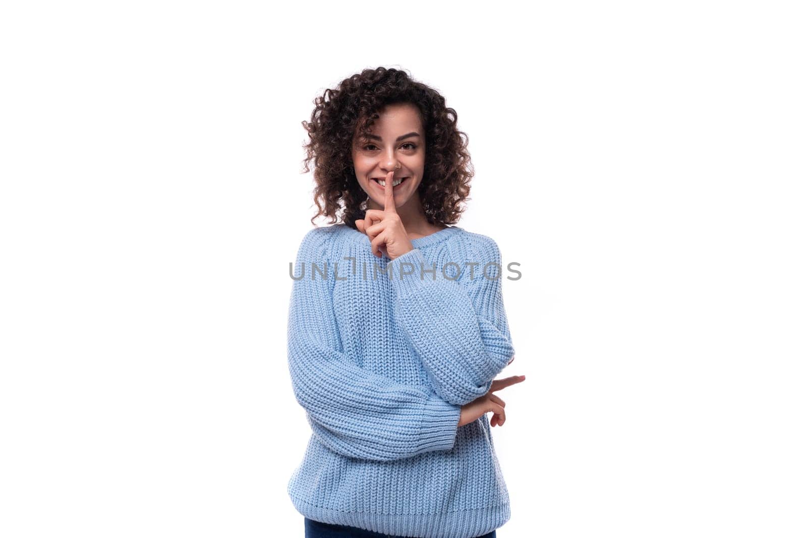 young pretty woman with curly method hairstyle smiling on background with copy space.