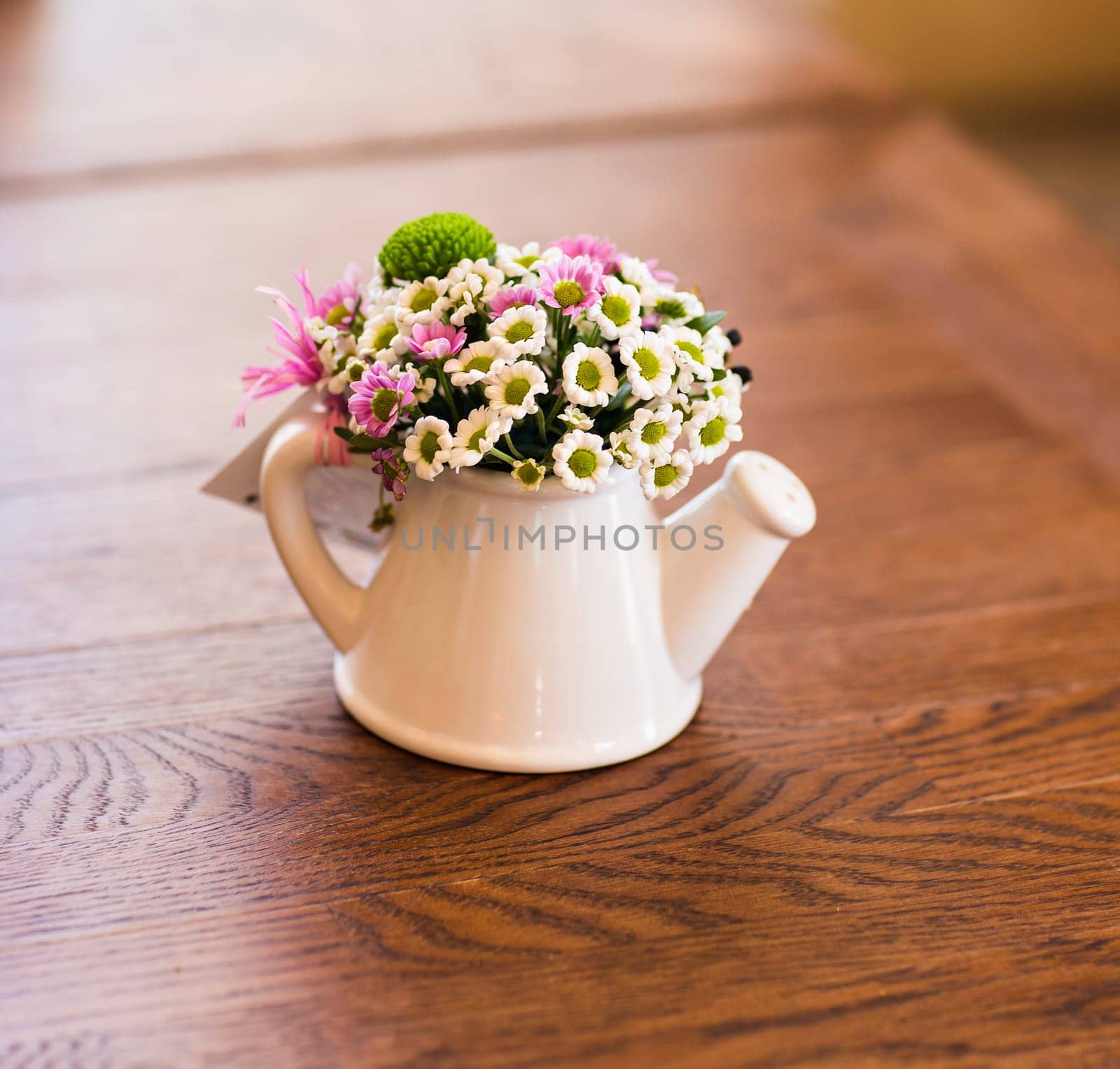 Close-up of artificial flowers in white watering by Satura86