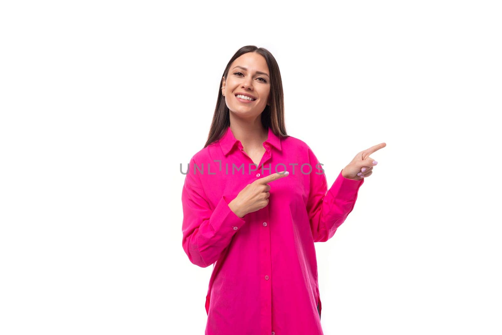 a smart caucasian woman with black straight hair is dressed in a crimson shirt with her index finger pointing at an empty space.