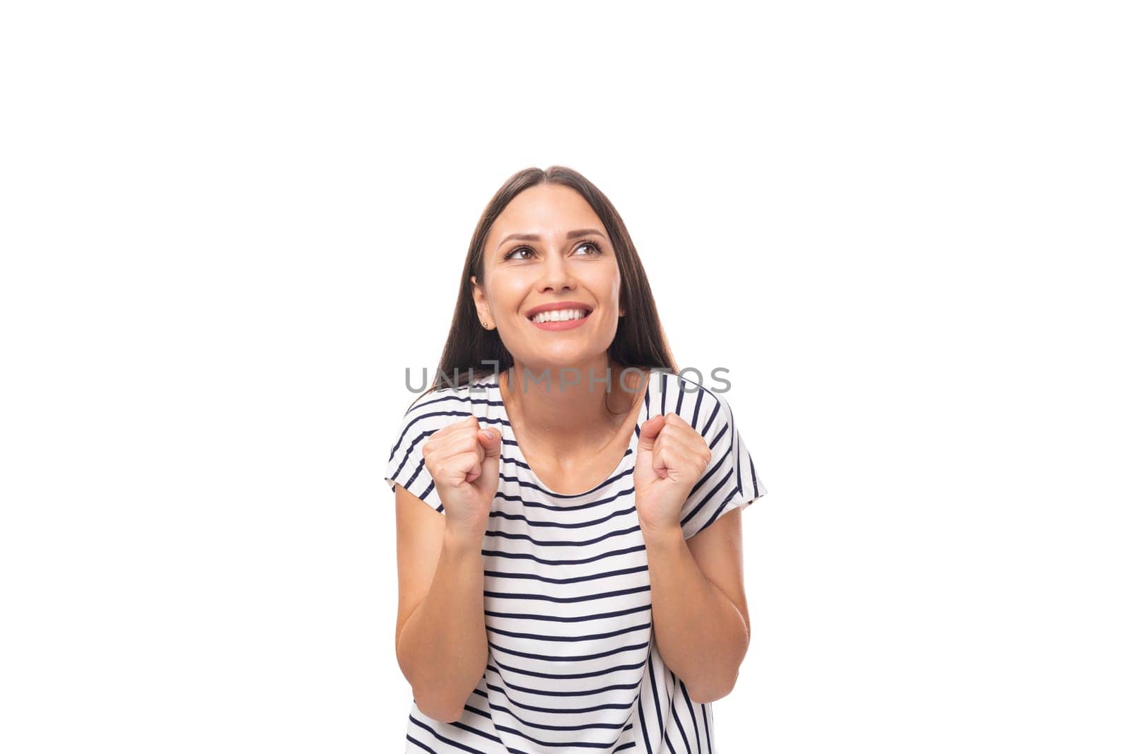 young positive brunette lady with straight hair in glasses is wearing a striped t-shirt smiling on a white background with copy space by TRMK