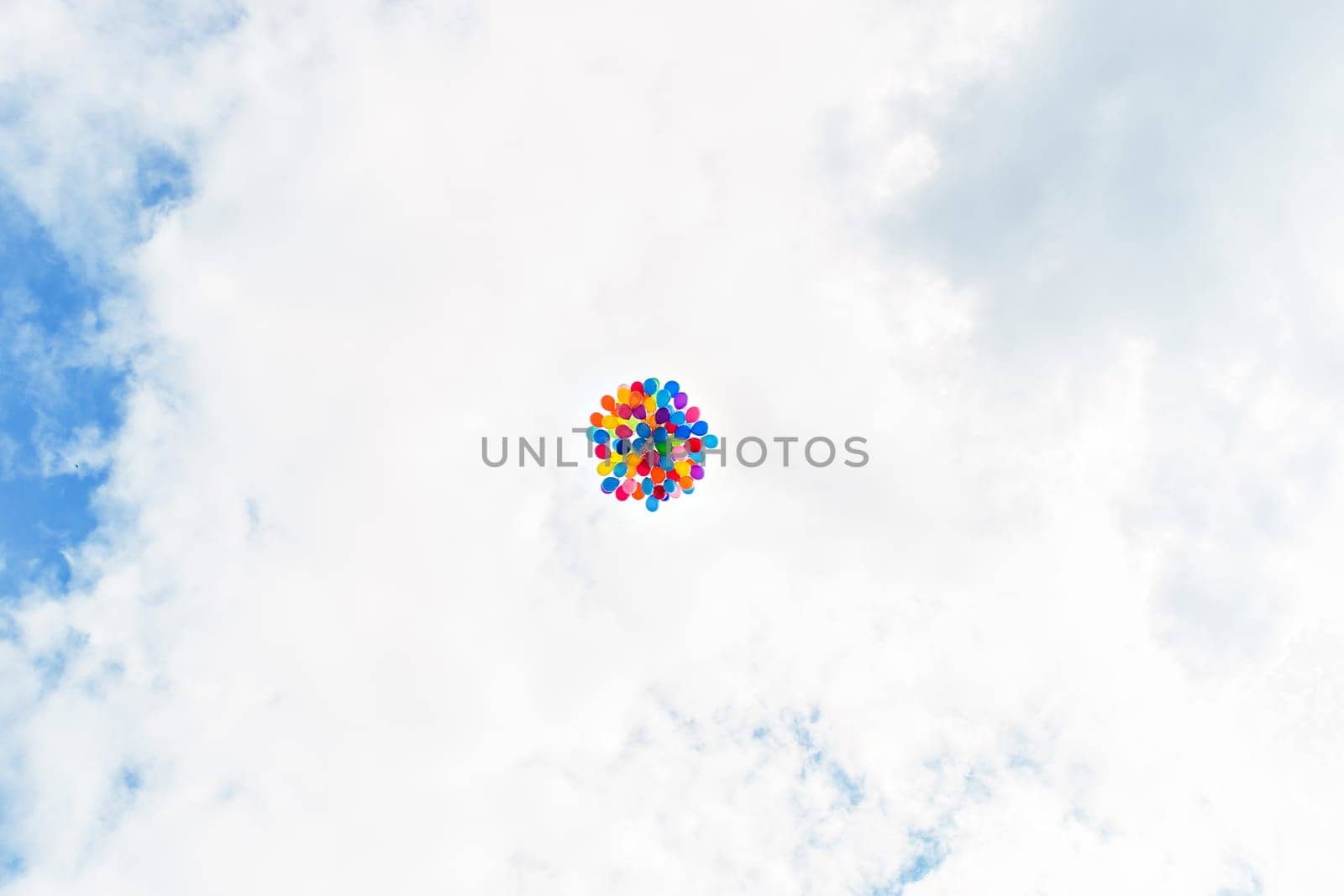 multicolored balloons flying in the blue sky