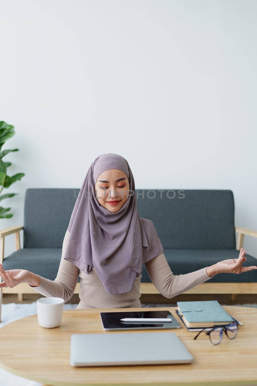 Muslim female employee Meditate while working in the office