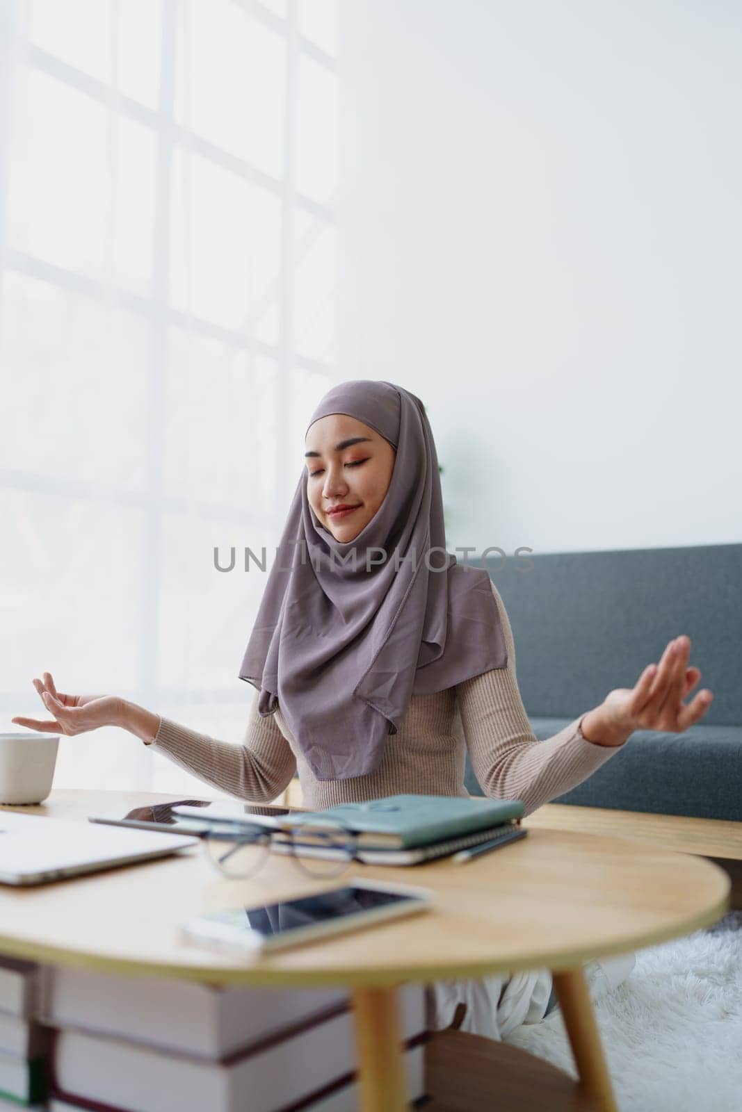 Muslim female employee Meditate while working in the office