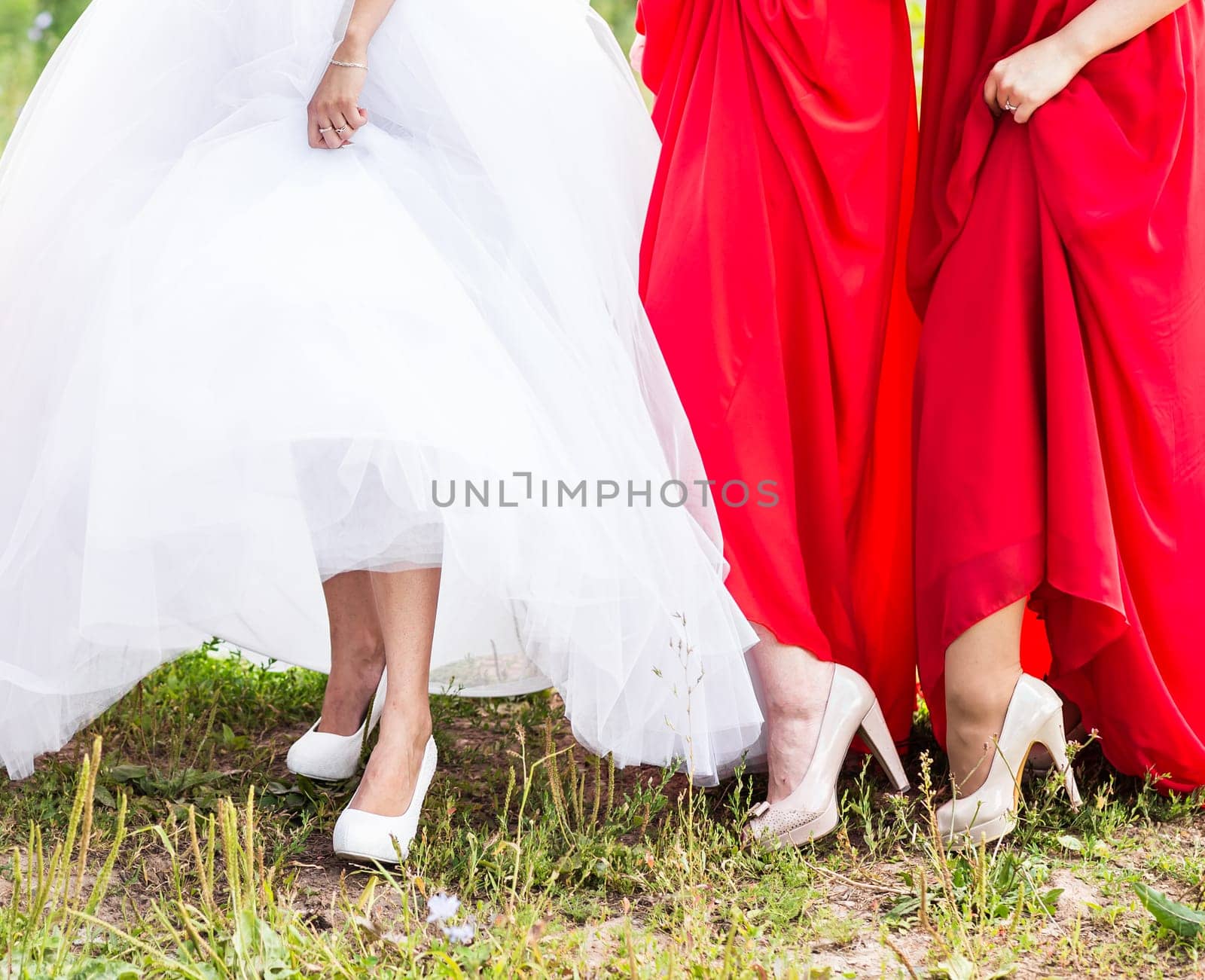 Bride and bridesmaids show off their shoes at wedding. by Satura86