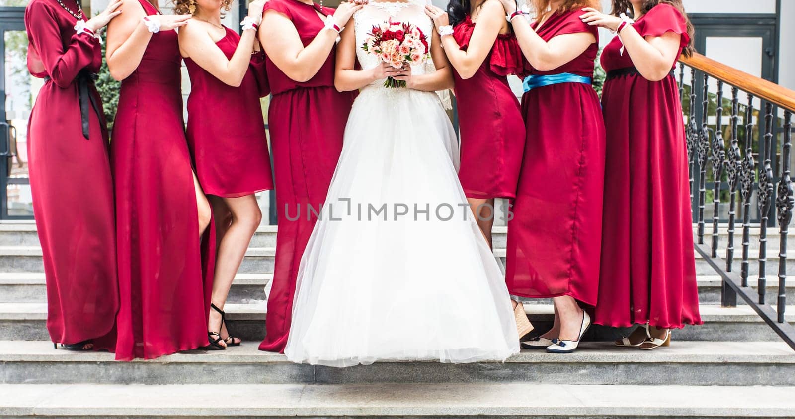 Bride with bridesmaids outdoors on the wedding day by Satura86