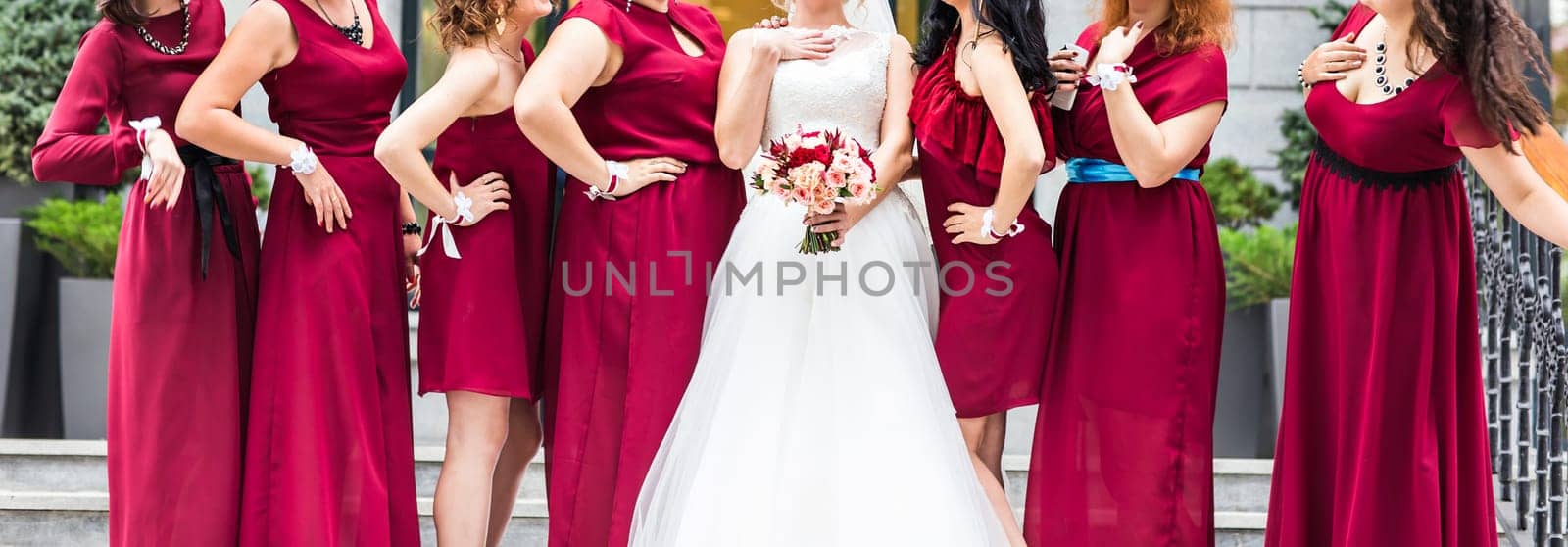 Bride with bridesmaids outdoors on the wedding day by Satura86