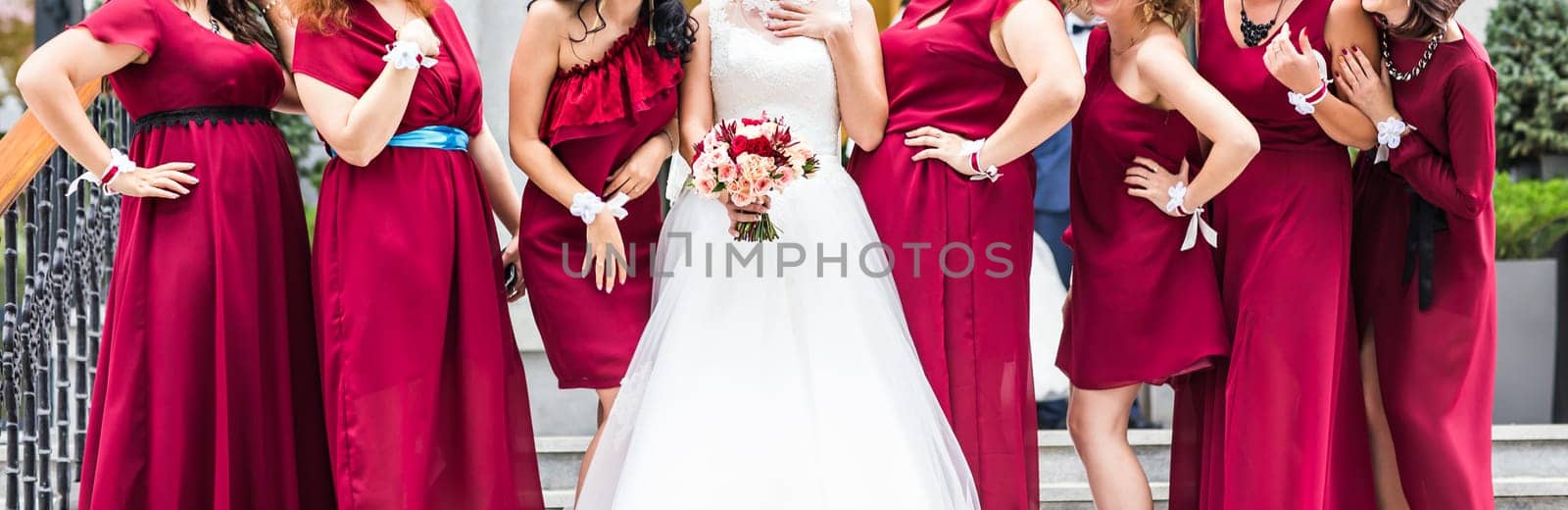 Bride with bridesmaids outdoors on the wedding day by Satura86