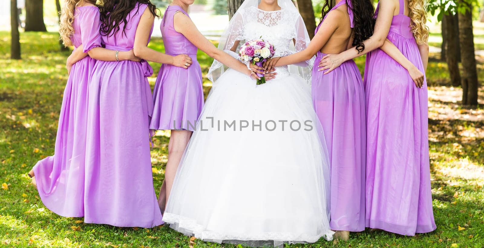 Bride with bridesmaids outdoors on the wedding day by Satura86