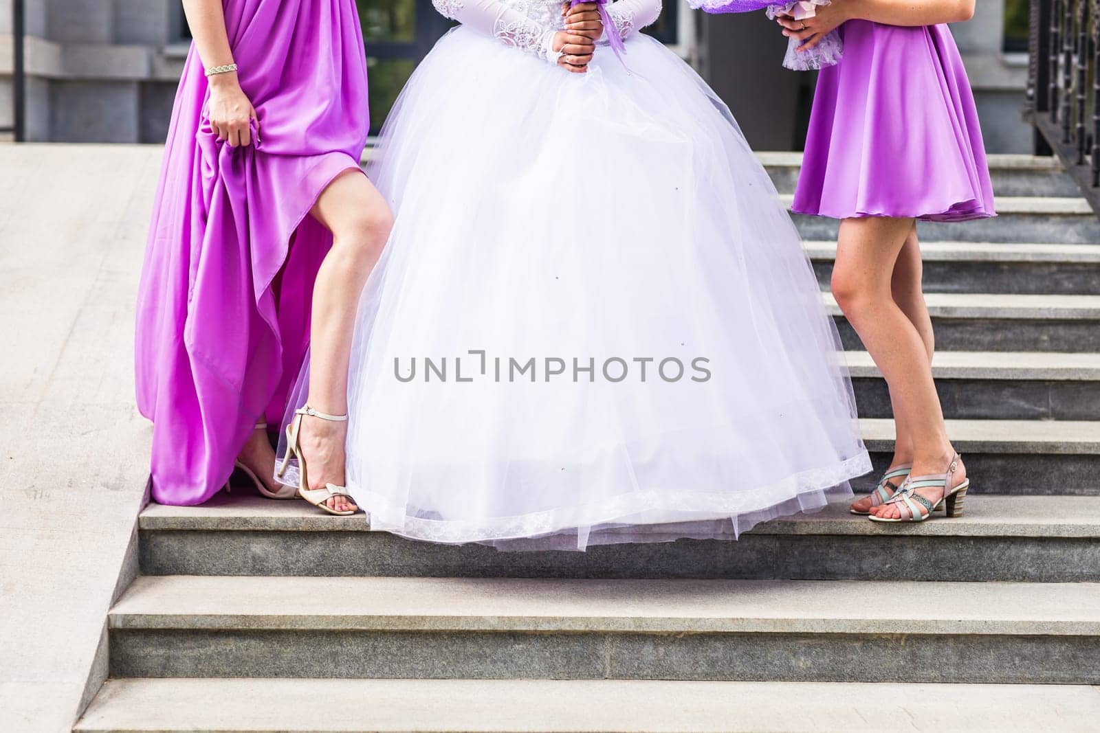 Bride with bridesmaids outdoors on the wedding day by Satura86
