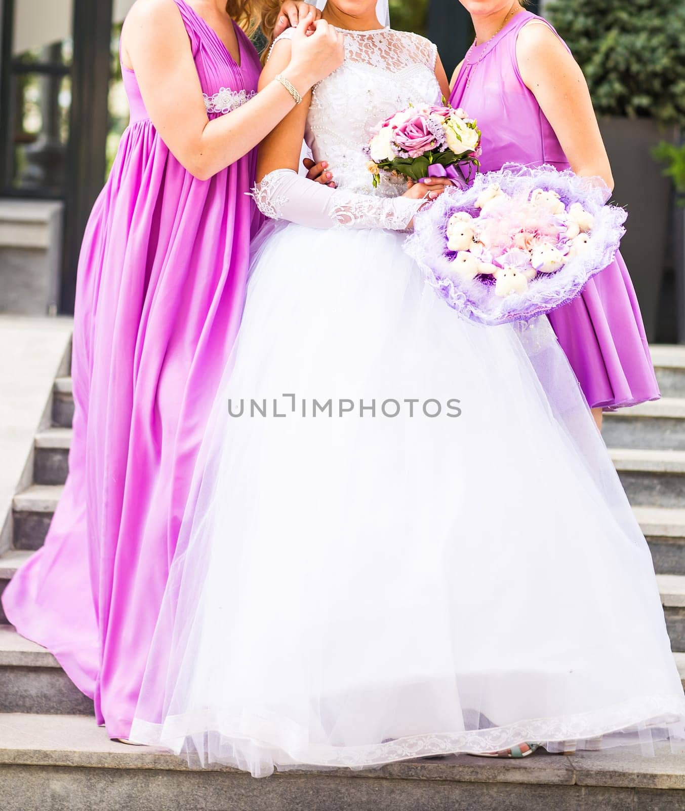 Bride with bridesmaids on the park on the wedding day