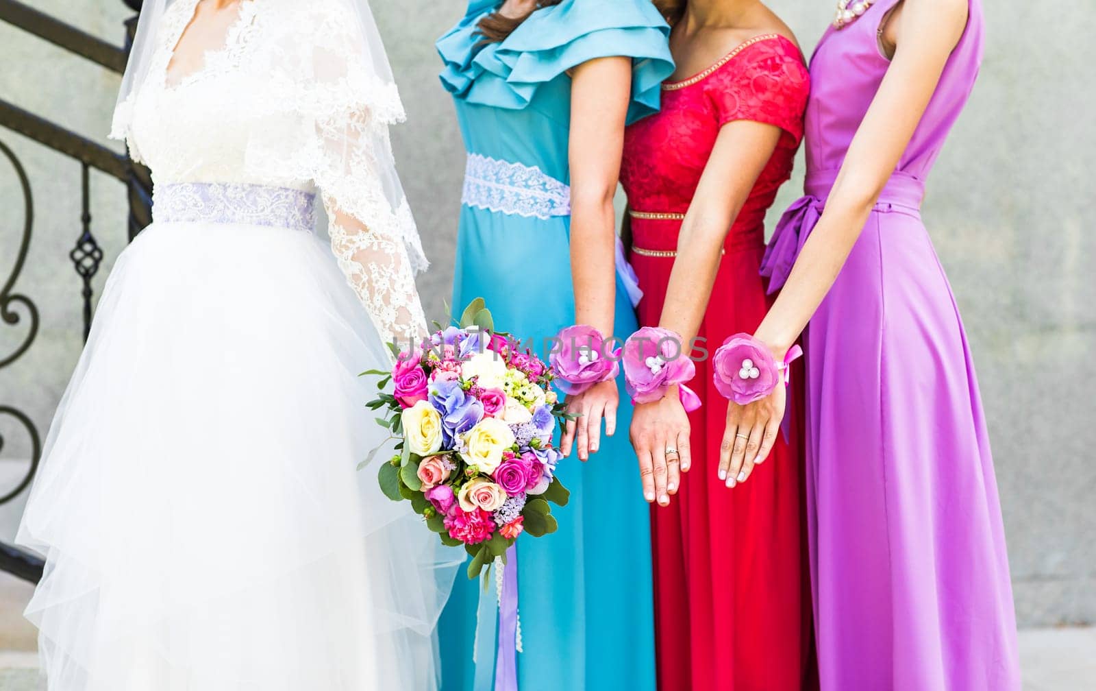 Bride with bridesmaids on the park on the wedding day