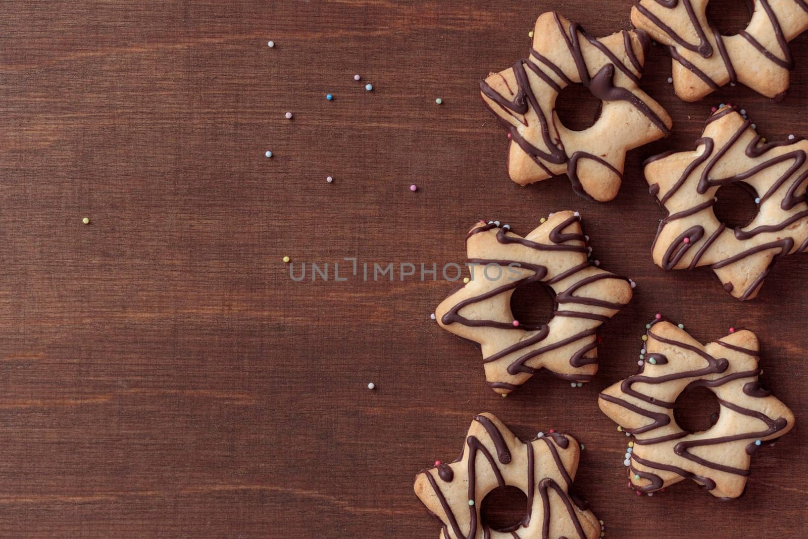 Freshly baked homemade star-shaped cookie with chocolate on the wooden table with a copy space, horizontal banner