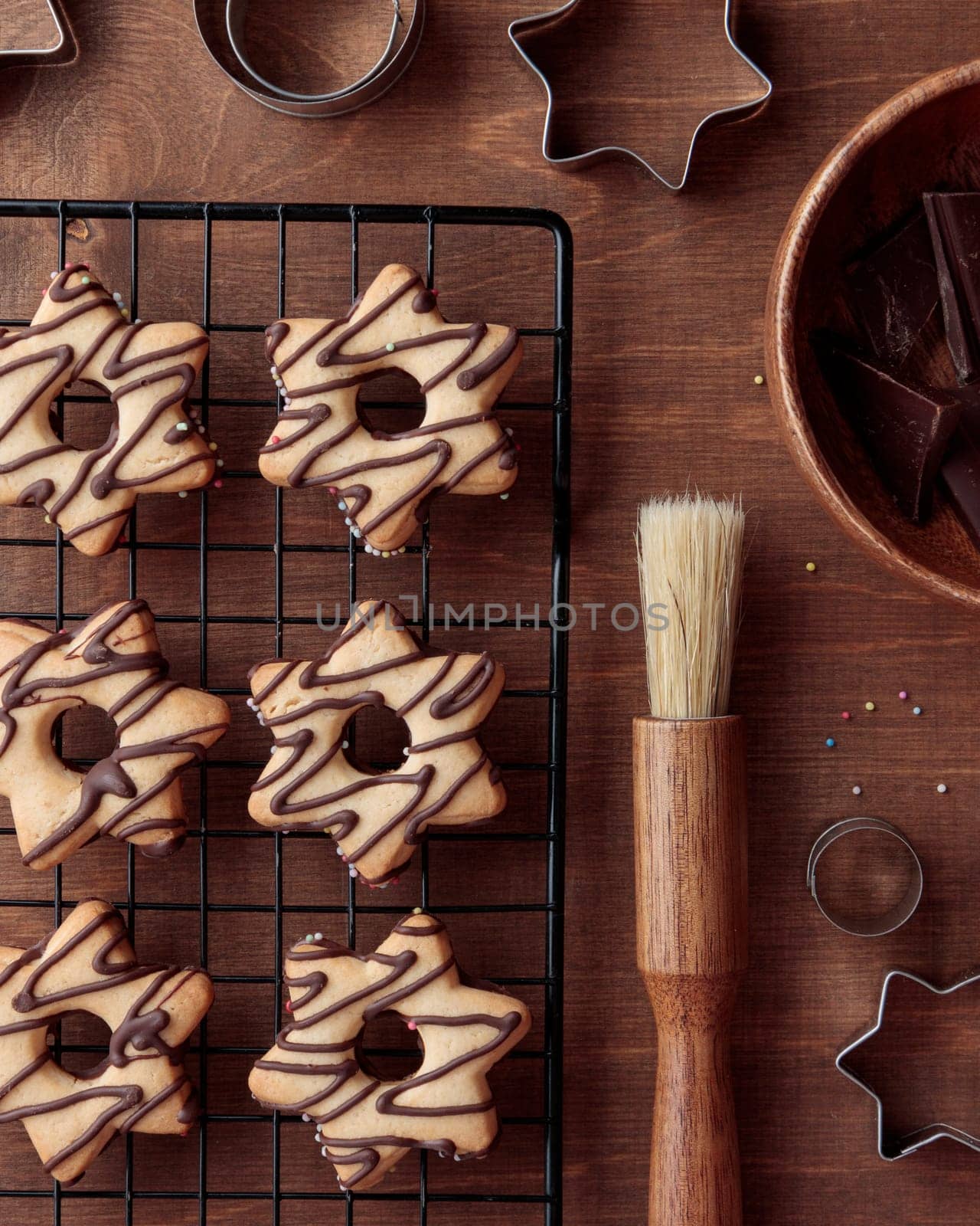Freshly baked homemade star-shaped cookie with chocolate on the grid on the wooden table