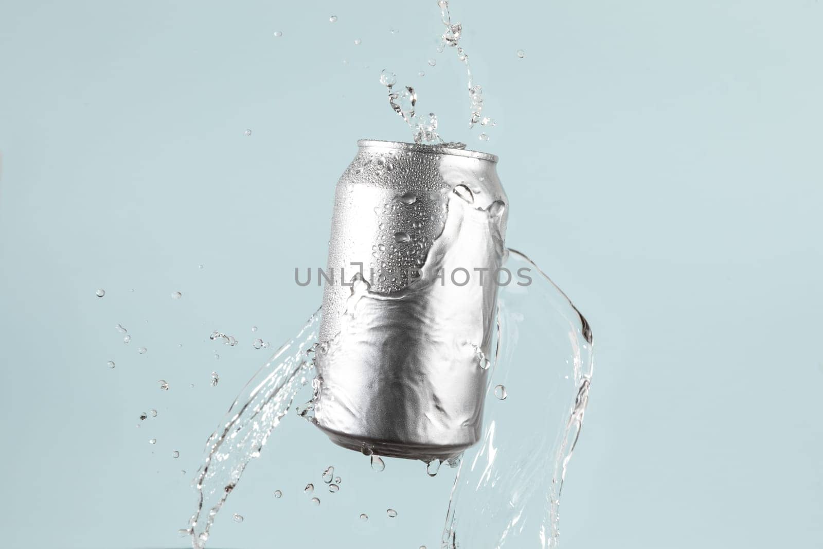 Aluminium beer or soda drinking can with water splash on light blue background by TropicalNinjaStudio