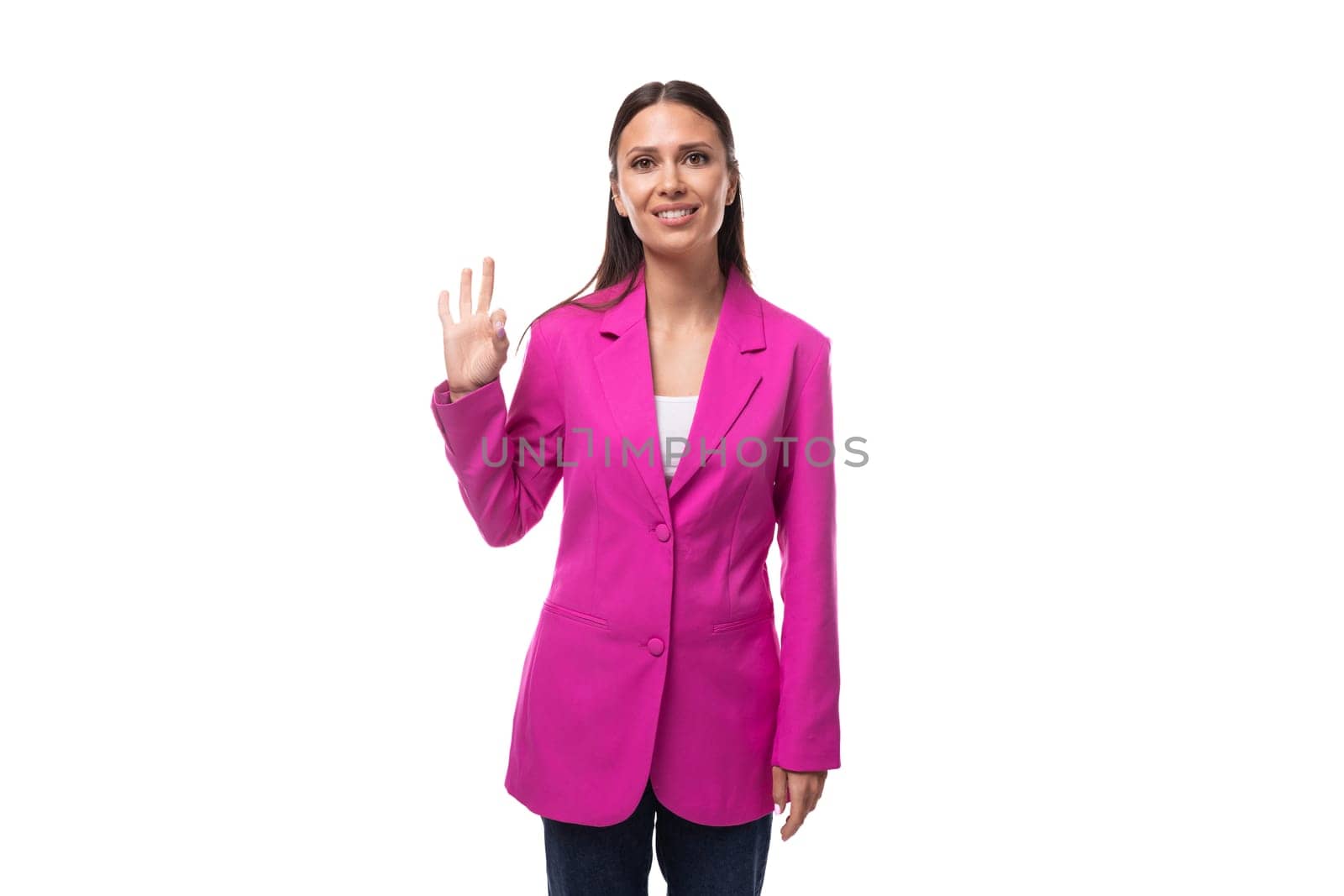 young confident successful brunette successful boss woman dressed in a stylish pink jacket.
