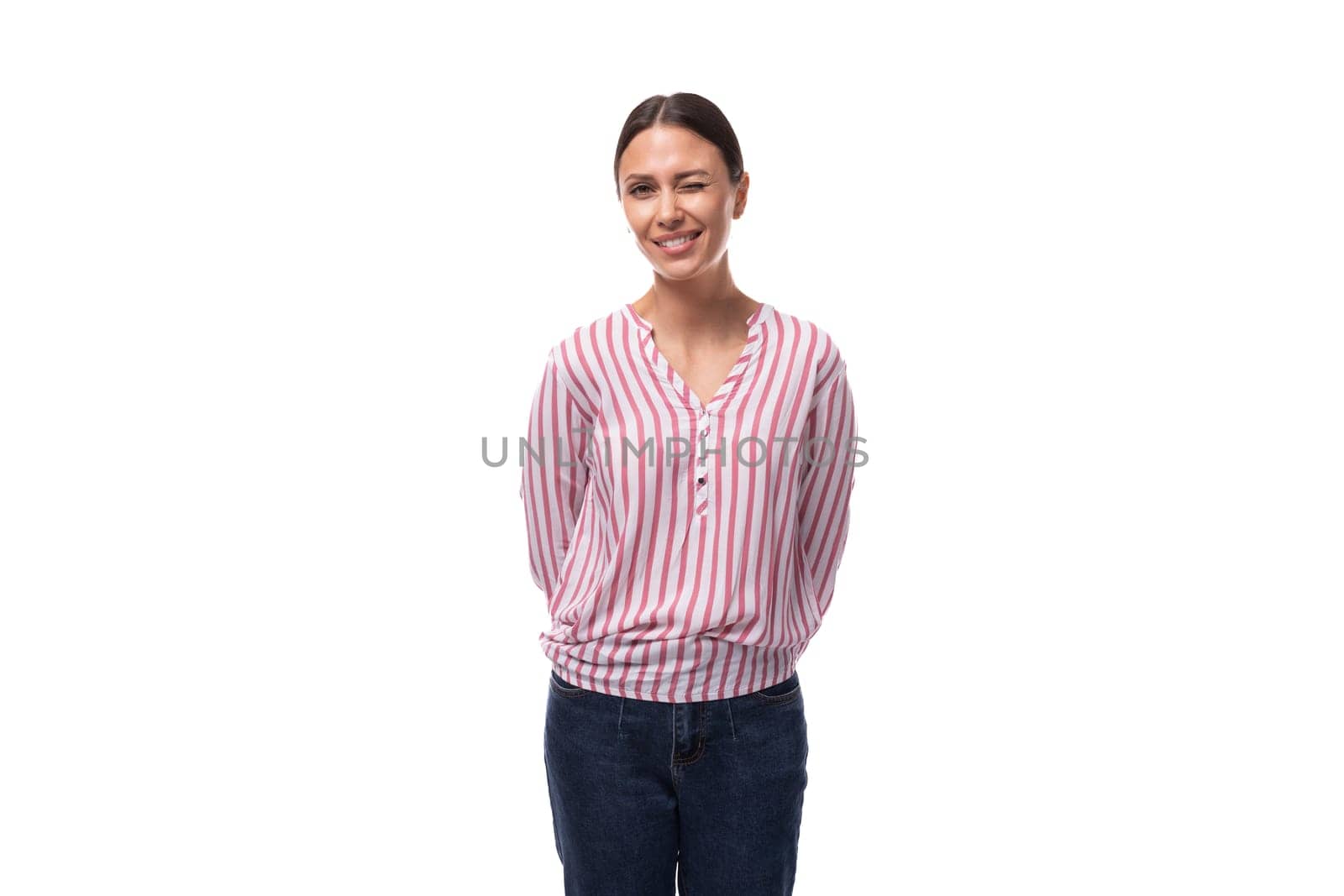 young charismatic caucasian woman with black hair gathered in a ponytail wearing a striped blouse by TRMK