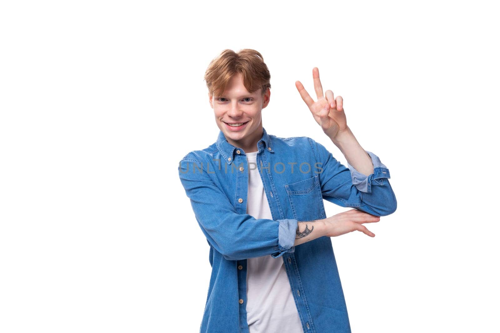 young red-haired guy in a blue shirt shows a gesture of class.