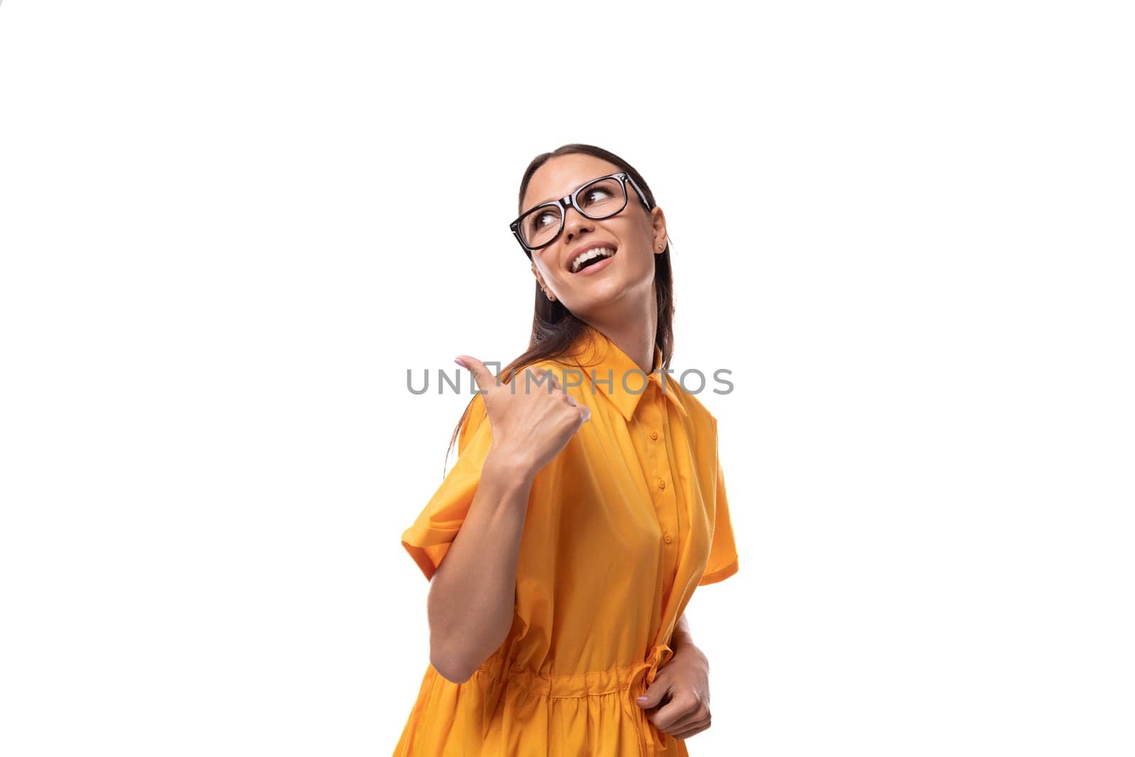 young well-groomed woman with black straight hair dressed in a yellow dress attracts attention.