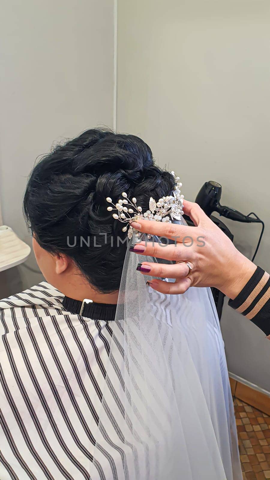 Wedding and holiday hairstyle. Braiding and hair styling in a beauty salon. Copy space