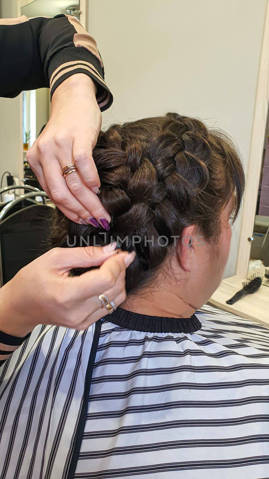 Wedding and holiday hairstyle. Braiding and hair styling in a beauty salon. Copy space