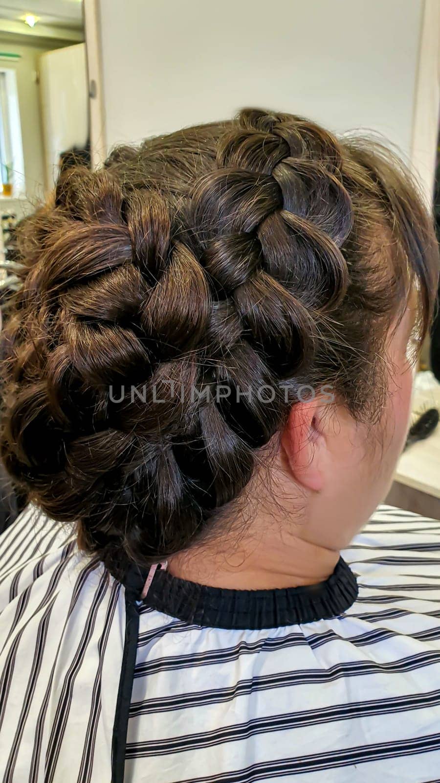 Wedding and holiday hairstyle. Braiding and hair styling in a beauty salon. Copy space