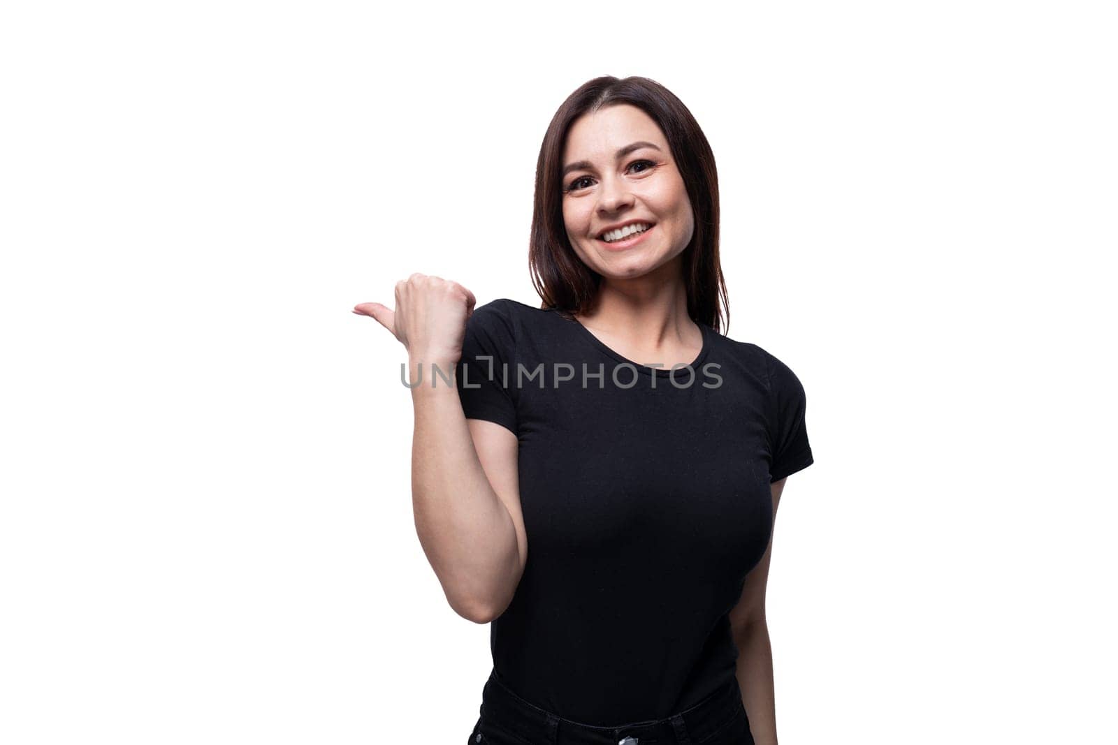 25 year old brunette woman with brown eyes points her finger to the side.