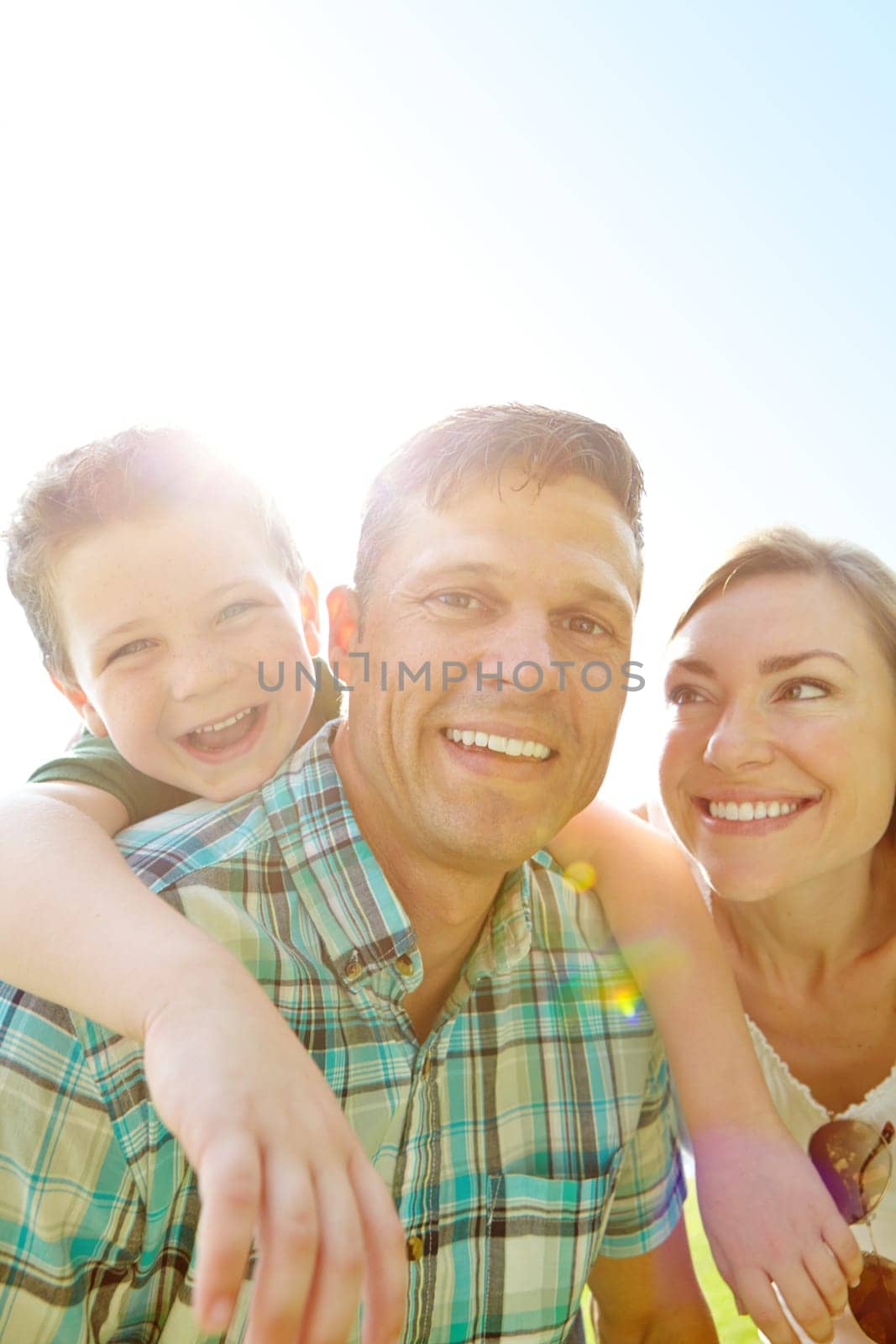 Enjoying time with his family. A cute young family spending time together outdoors on a summers day