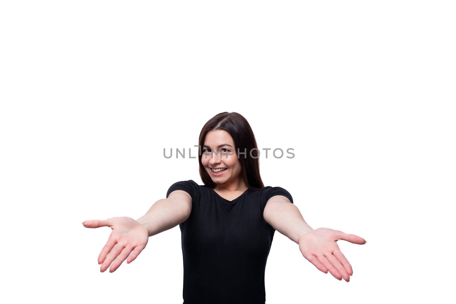 25 year old brunette woman with brown eyes greets and smiles against a background with copy space.