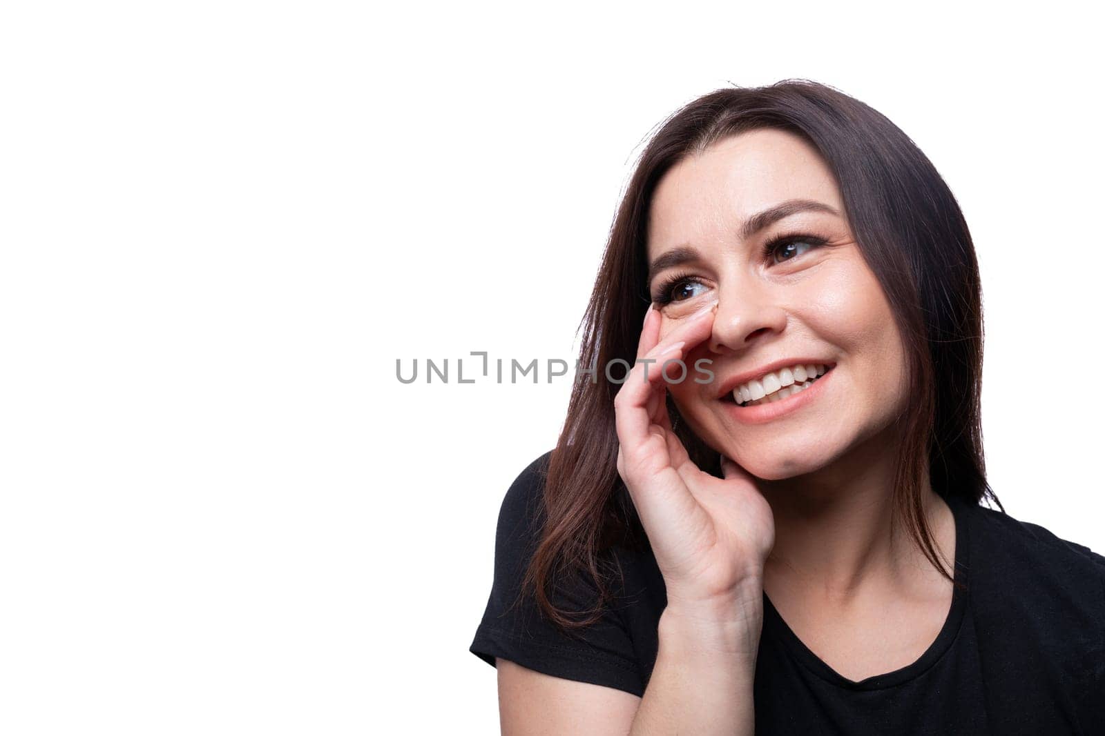 Young modest woman with brown eyes wearing a black T-shirt on a background with copy space by TRMK
