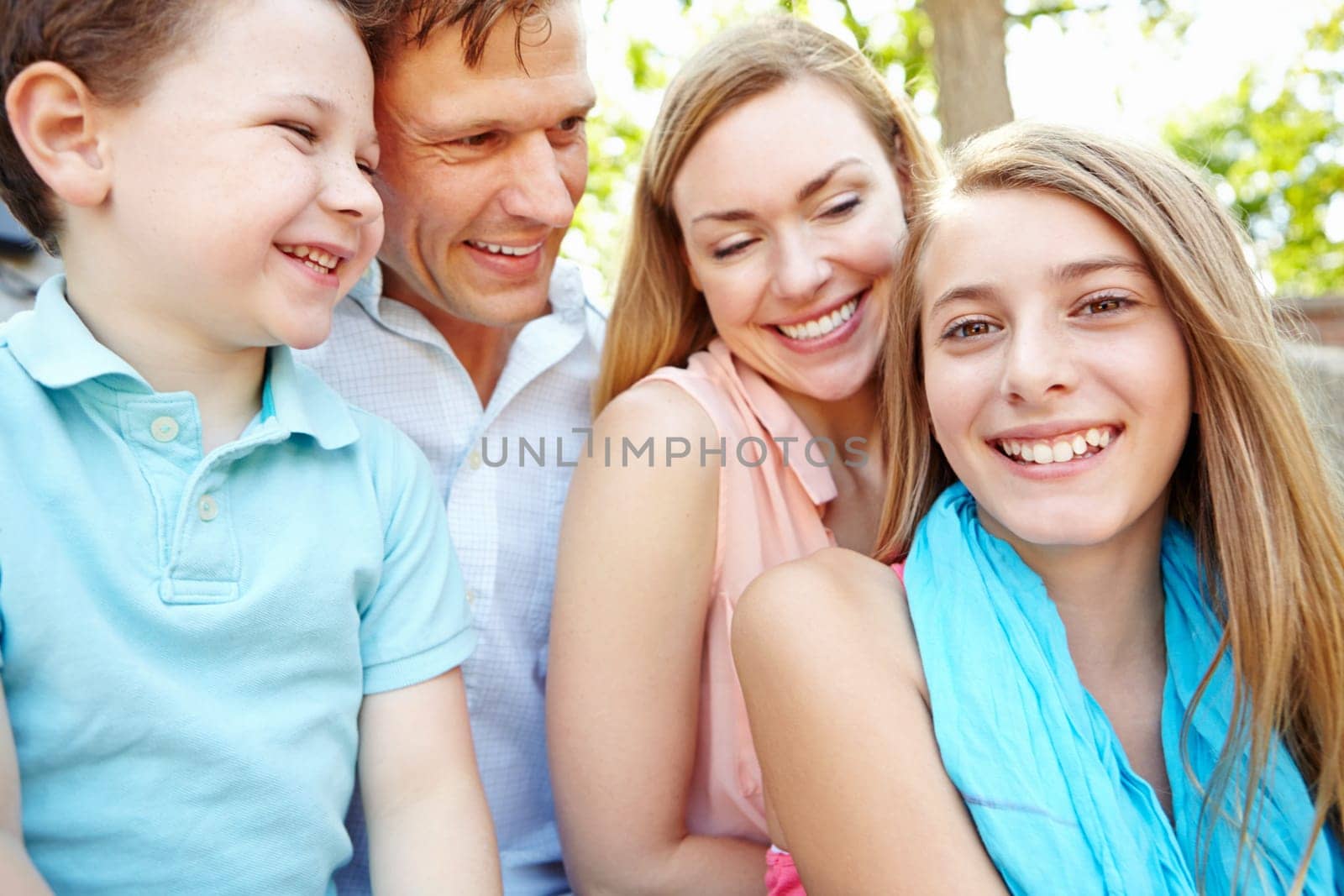 Spending time together in the park. Happy family smiling while outdoors