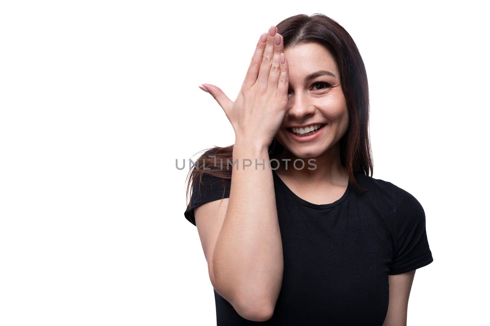 Young carefree woman with brown eyes wearing a black T-shirt, close-up portrait.