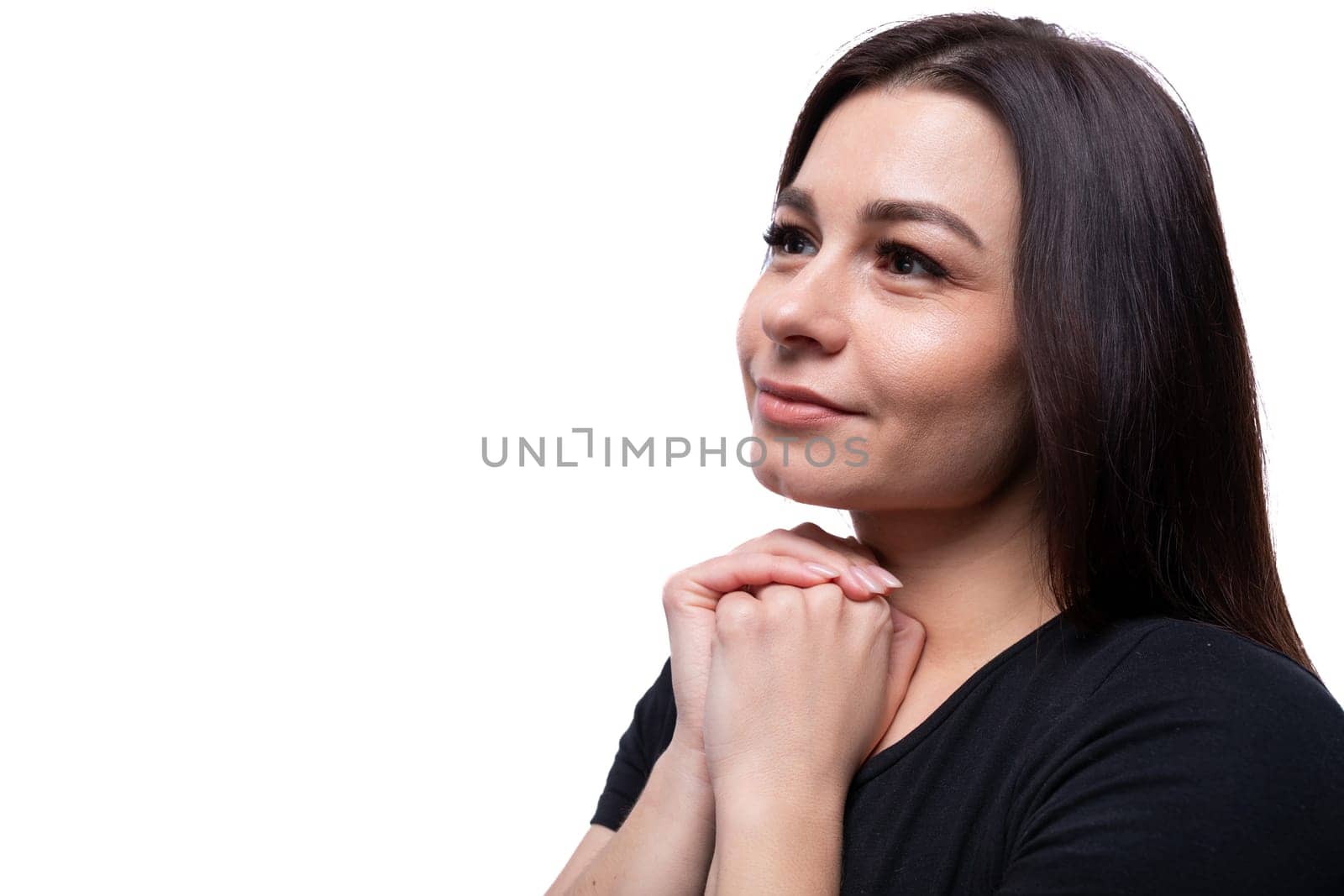 Young dreamy european woman dressed in basic t-shirt closeup.