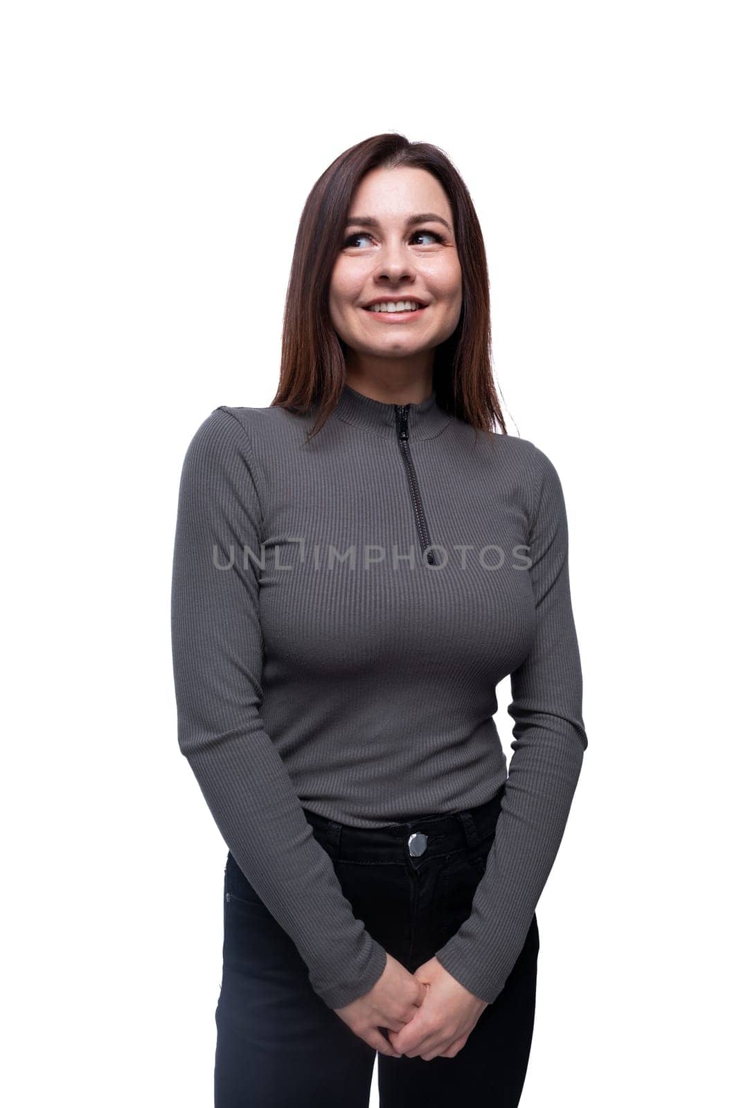 Caucasian young woman dressed in a tight-fitting blouse on a white background with copy space.