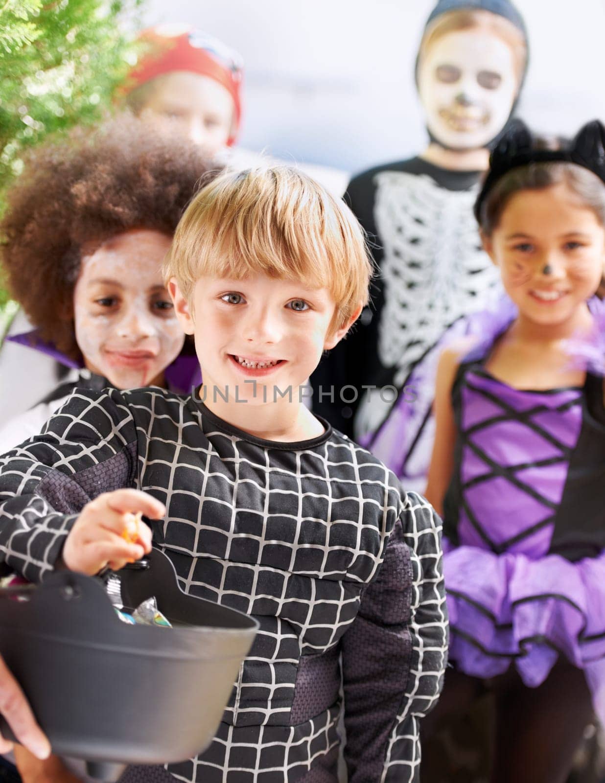 Trick-or-treating cuties. Portrait of happy little children trick-or-treating on halloween