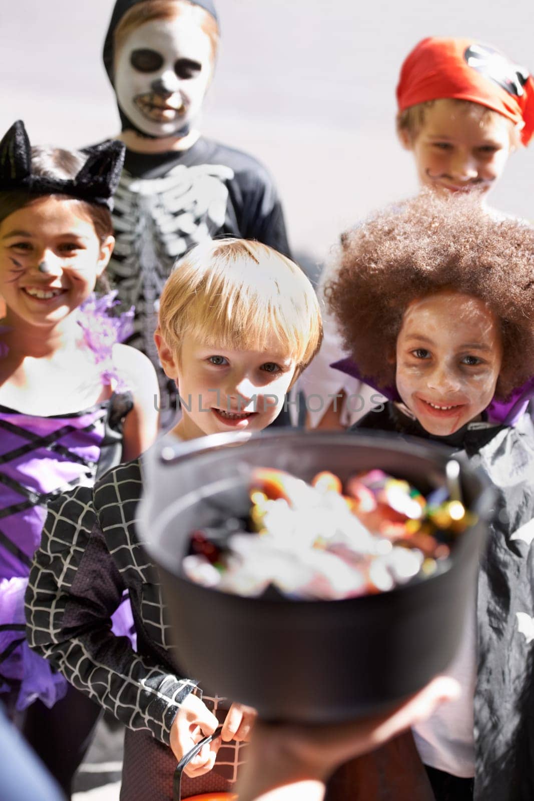 Every childs favorite holiday. Portrait of a group of little children trick-or-treating on halloween