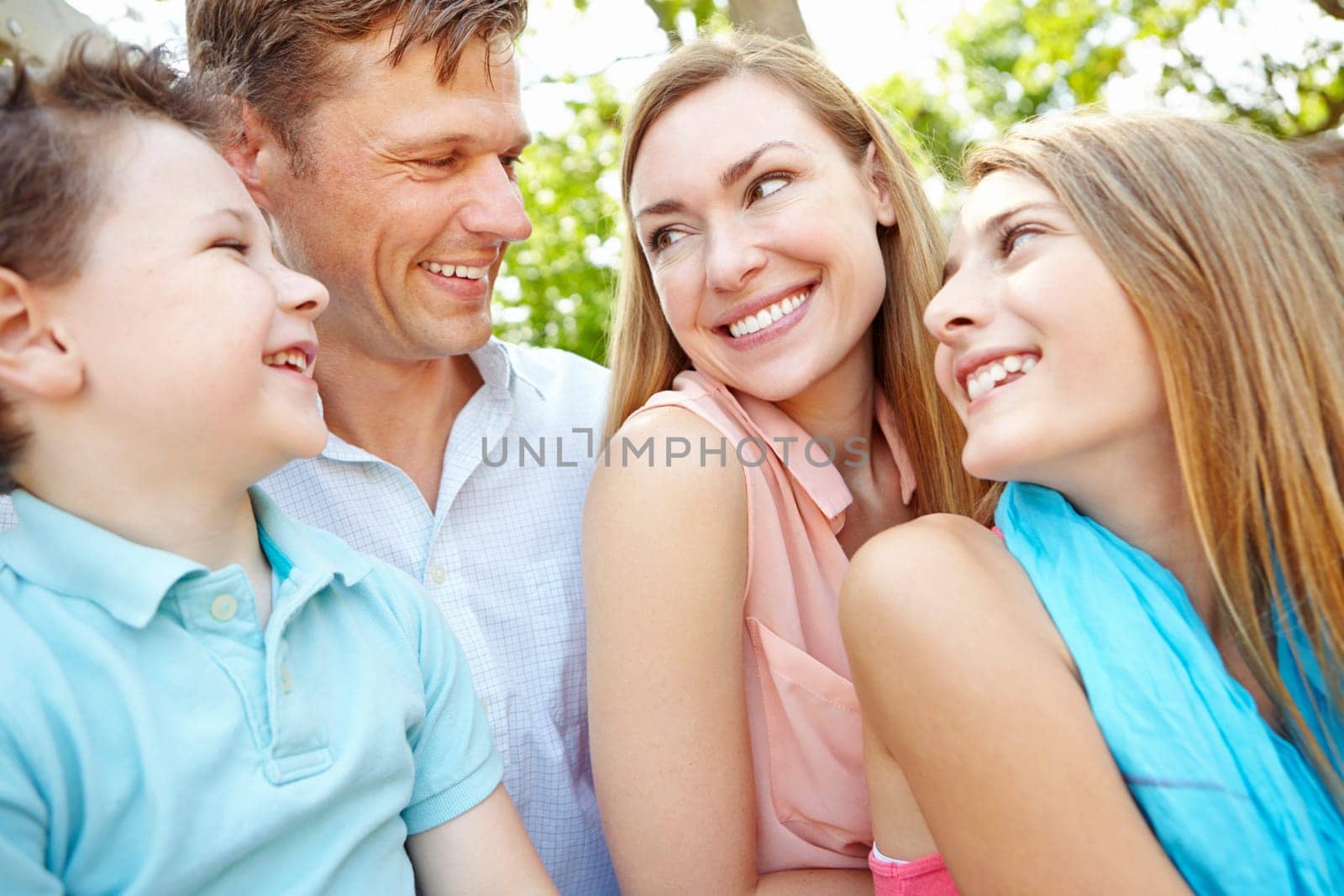 Quality family time in the park. Happy family smiling while outdoors