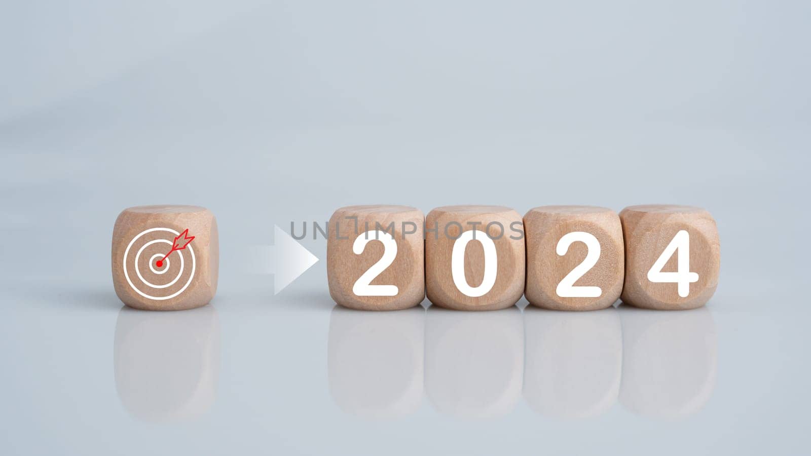 Wooden blocks lined up with the letters 2024. Represents the goal setting for 2024, the concept of a start. financial planning development strategy business goal setting by Unimages2527