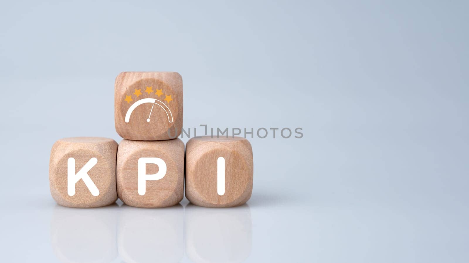 Wooden cube block with KPI short for Key Performance Indicators on white background. Business concept, business goals, performance results and financial business concept.