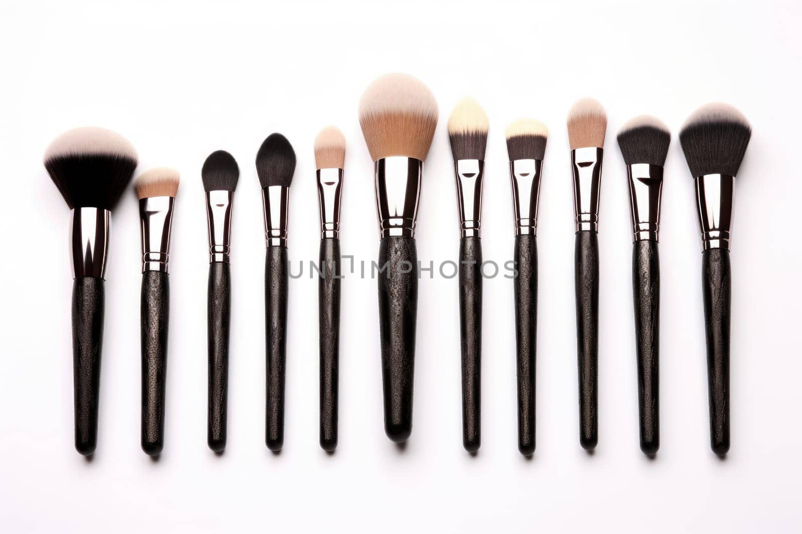 Set of professional makeup brushes on a white background.
