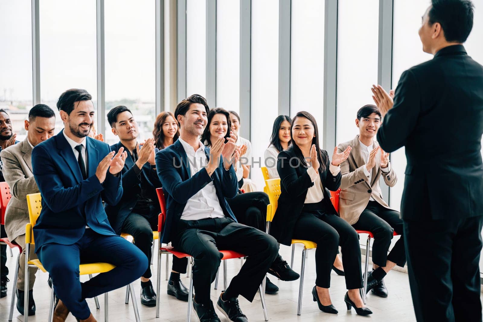 Teamwork triumph Business colleagues applaud and cheer in an office space, celebrating the success of a new product. Clapping hands signify unity, motivation, and shared achievements. by Sorapop