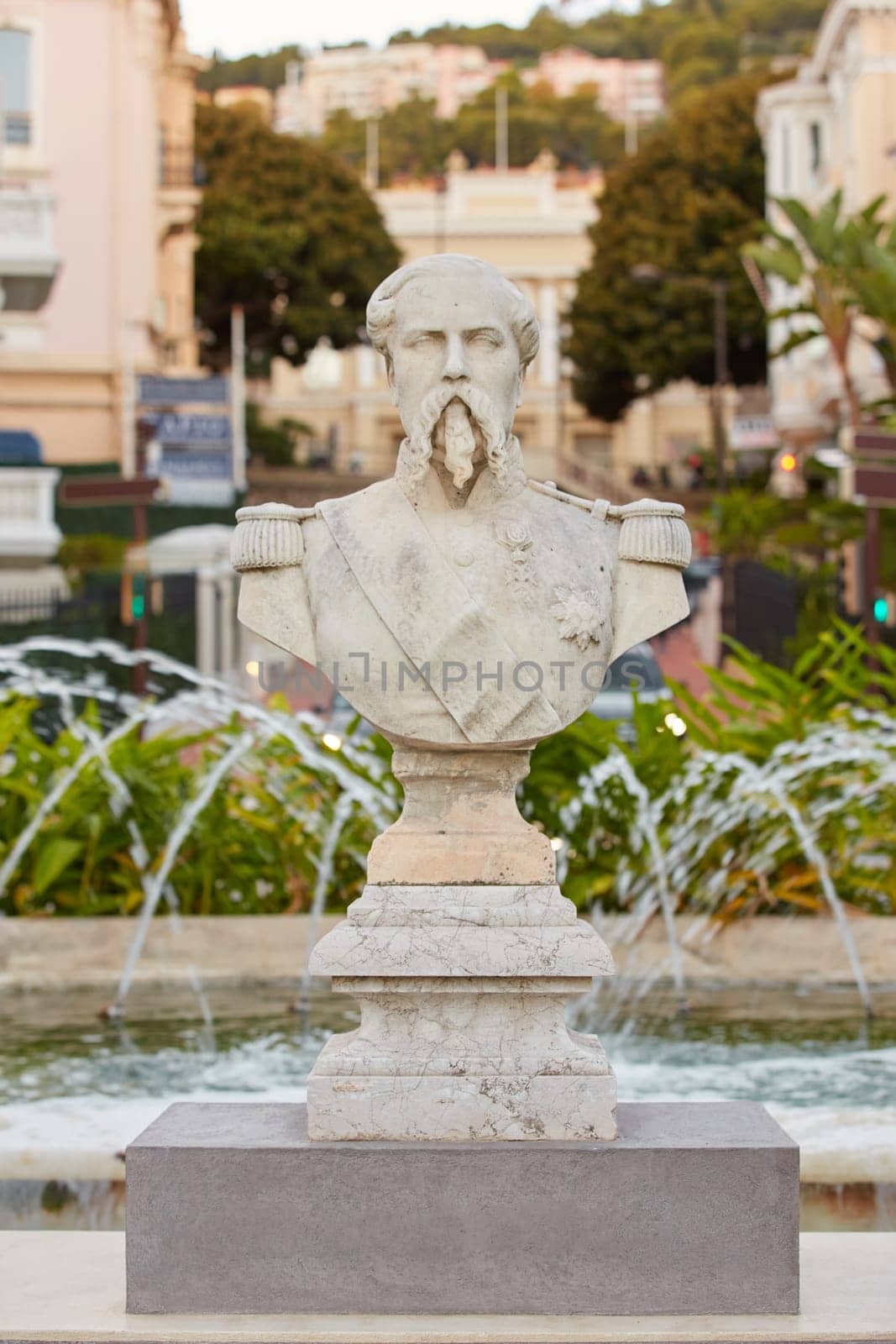 Monaco, Monte-Carlo, 12 November 2022: The famous square of Casino Monte-Carlo is at dusk, attraction night illumination, luxury cars, players, tourists, splashes of fountain. High quality photo