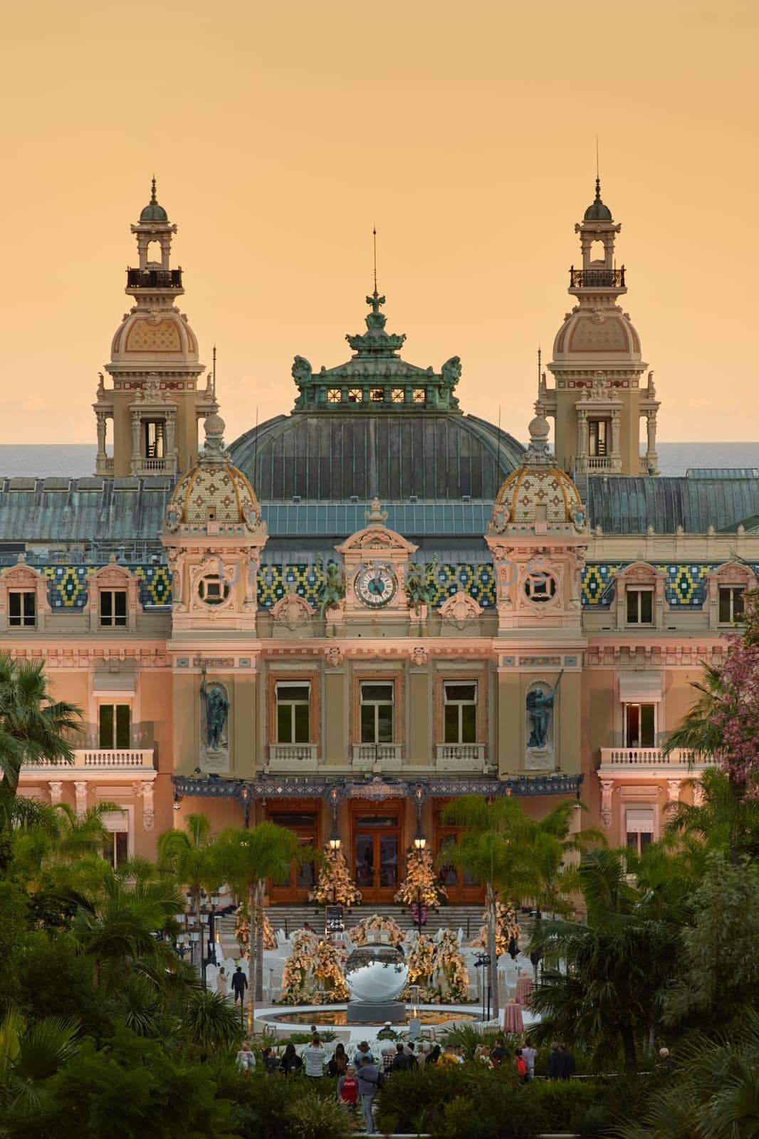 Monaco, Monte-Carlo, 12 November 2022: The famous square of Casino Monte-Carlo is at dusk, attraction night illumination, luxury cars, players, tourists, splashes of fountain. High quality photo