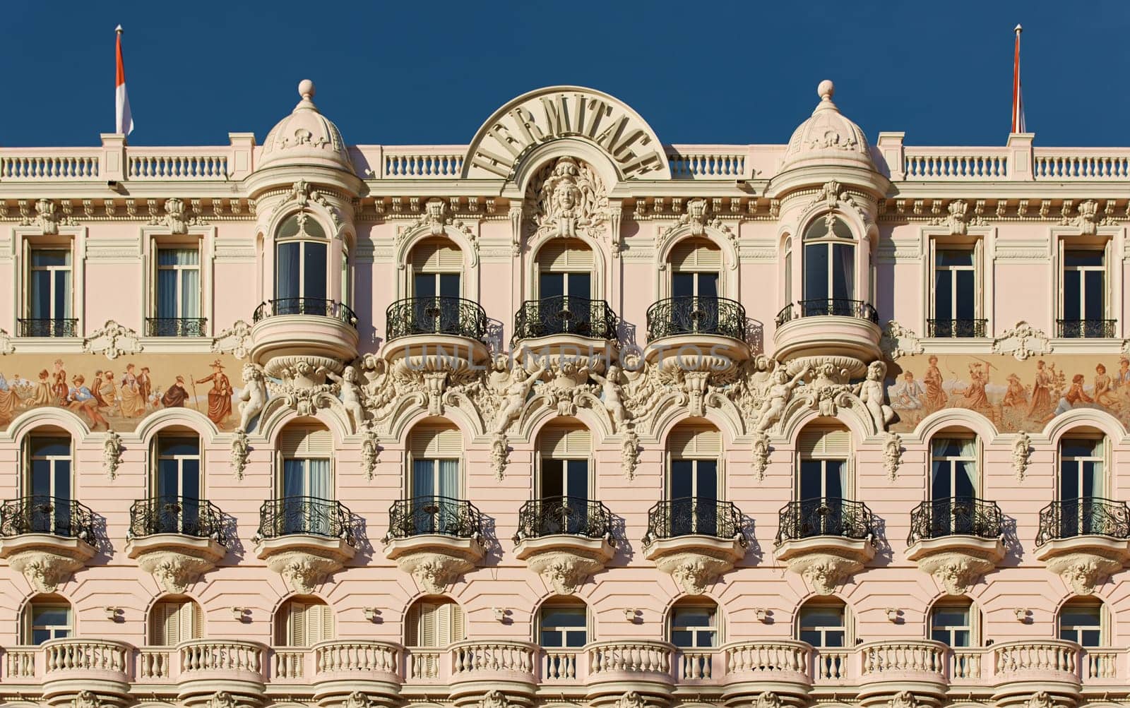 Monaco, Monte Carlo, 27 September 2022: The facade of famous Hotel Hermitage at sunny day, building of yellow color, balcony, bas-relief. High quality photo