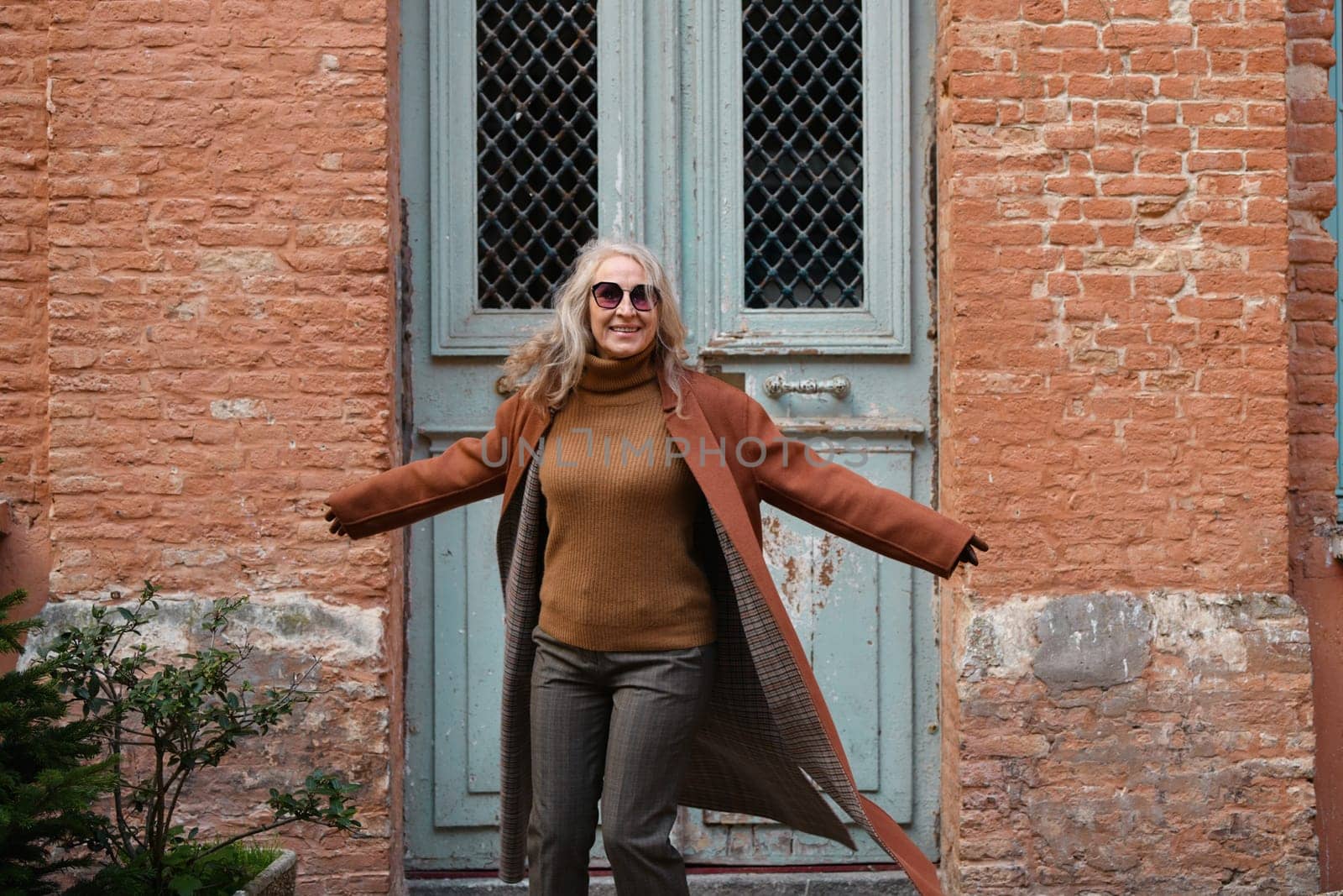 Woman in terracotta coat and leather gloves